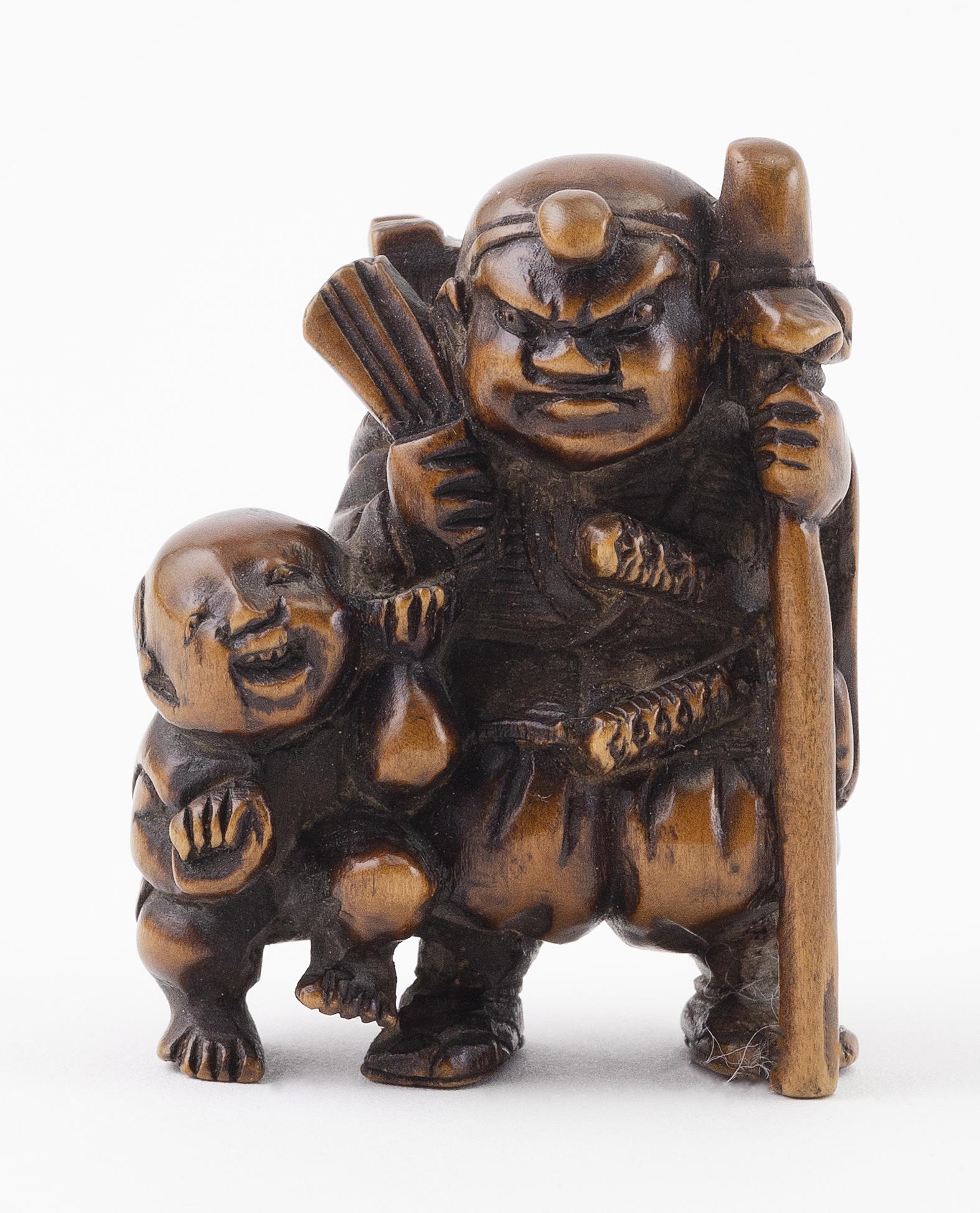 JAPANESE WOOD NETSUKE Meiji Period Height 2".: JAPANESE WOOD NETSUKE Meiji Period An old man with a fan and a staff standing next to a child with a sack. Signed. Height 2". Provenance: Private Wisconsin Collection.