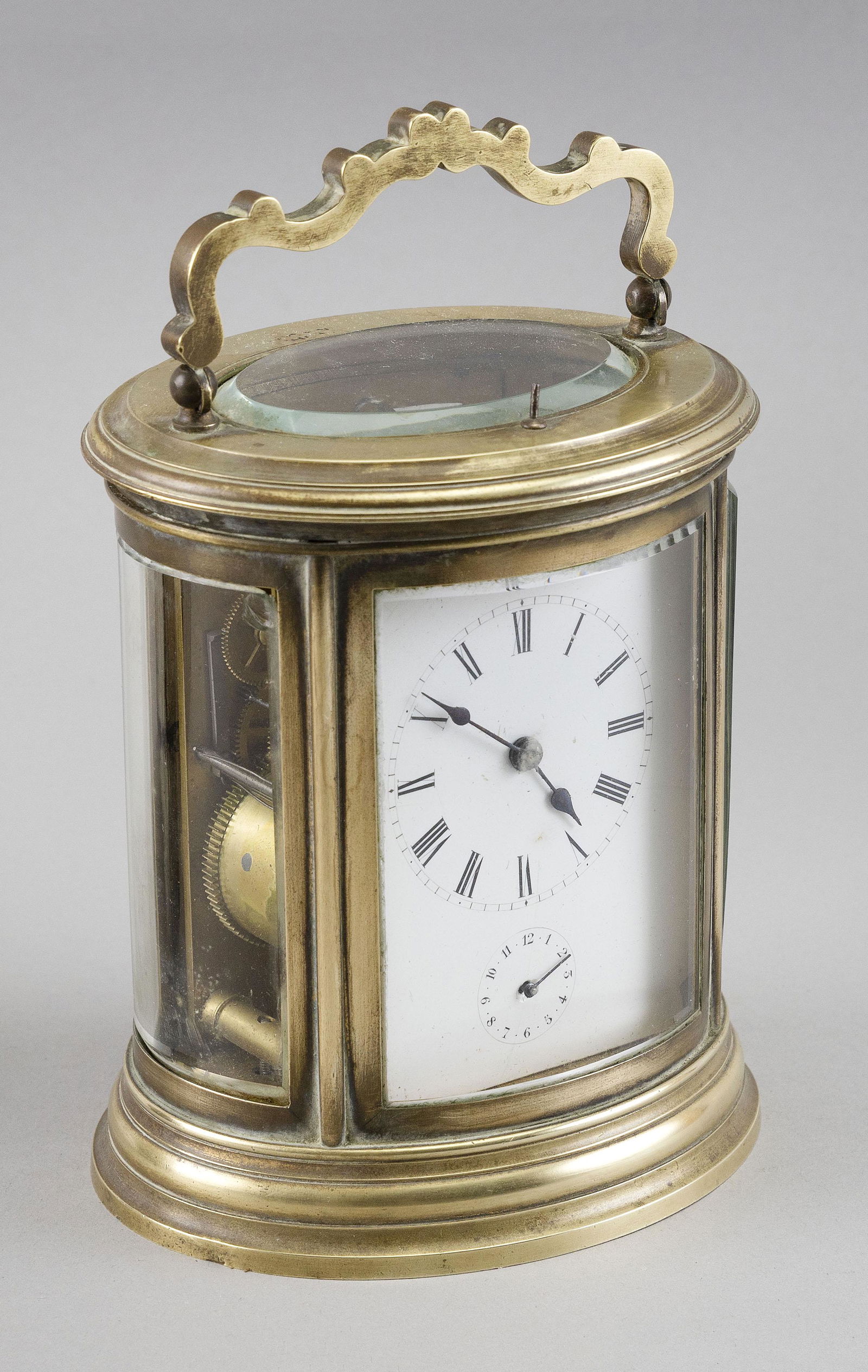 FRENCH OVAL CARRIAGE CLOCK 19th Century Height 7.5”. Width 5”. Depth 4”. (1 of 2)