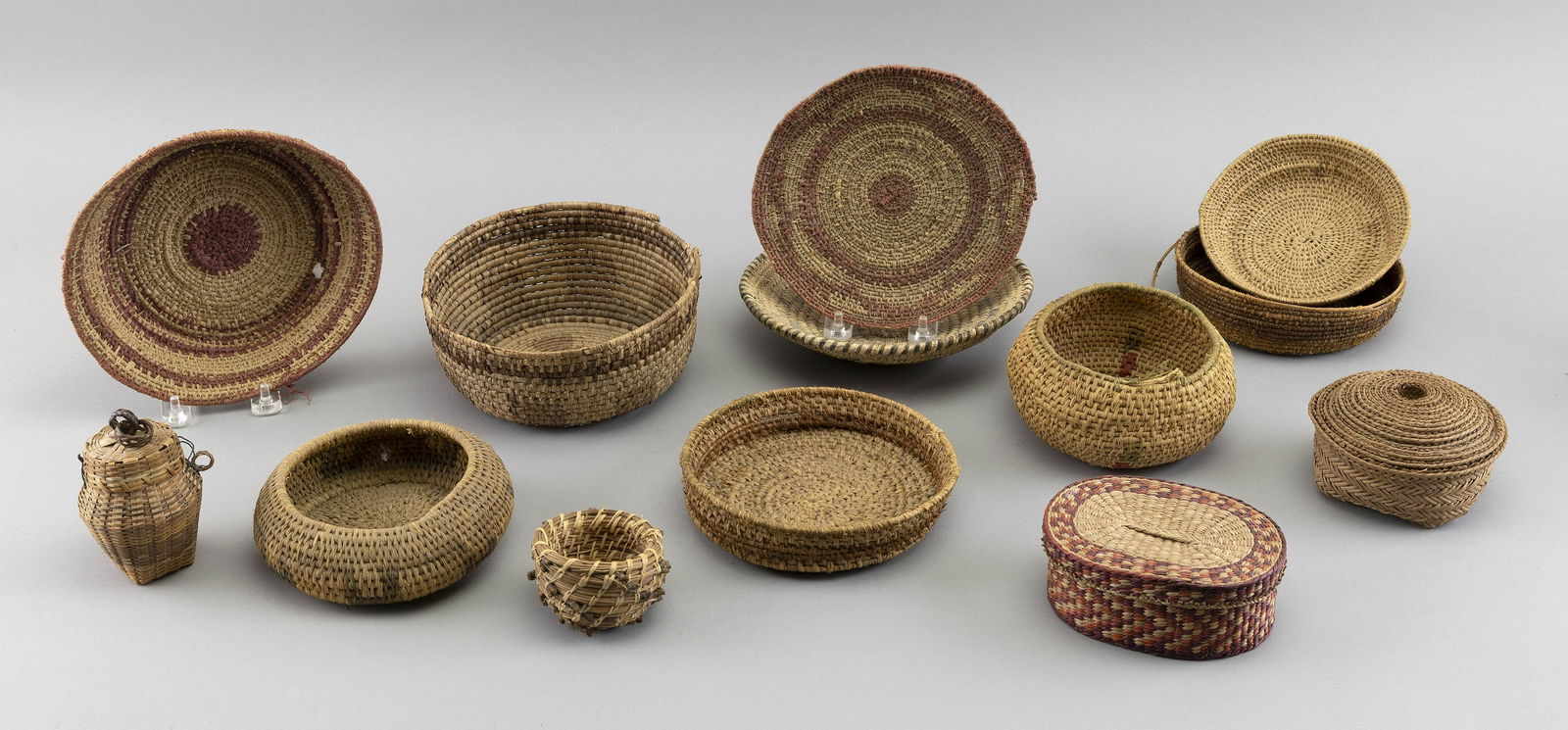THIRTEEN SMALL AMERICAN INDIAN BASKETS 20th Century Diameters from 3” to 7.5”. (1 of 1)