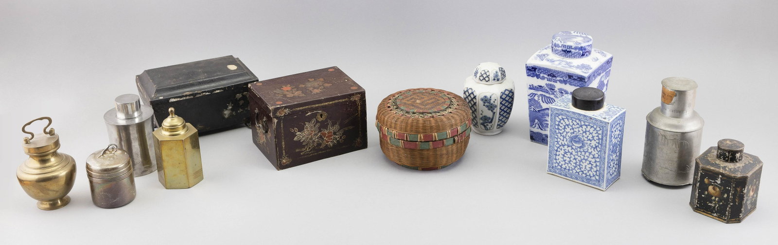 TWELVE TEA CADDIES 19th/20th Century Heights from 3” to 9”.: TWELVE TEA CADDIES 19th/20th Century Three porcelain, three brass, three tin, two pewter and one lacquer. Heights from 3” to 9”.