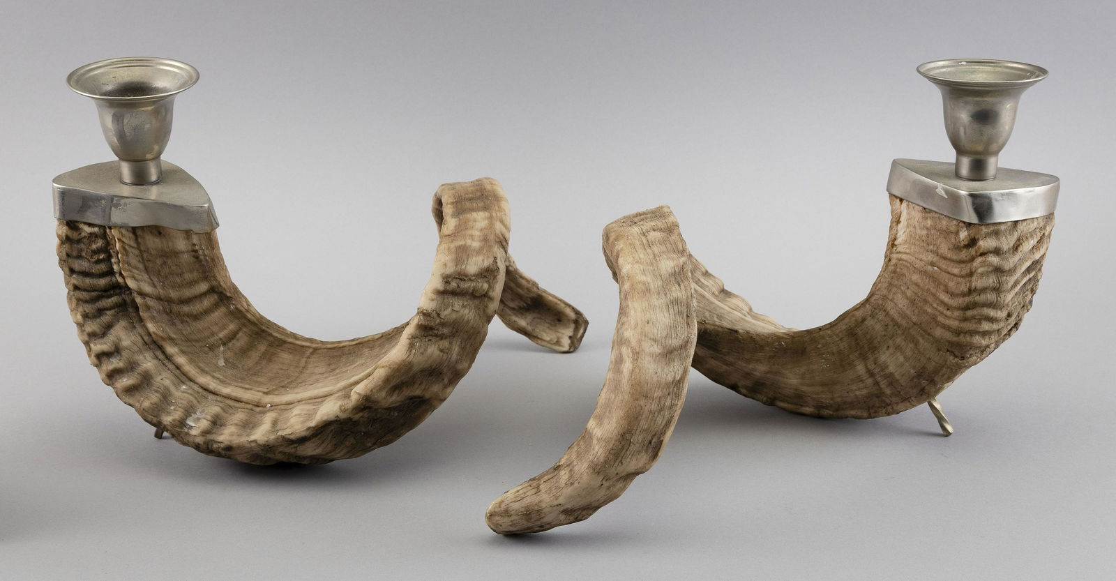 PAIR OF ALUMINUM AND RAM'S HORN CANDLE HOLDERS Heights 8”. Lengths 12”. (1 of 2)