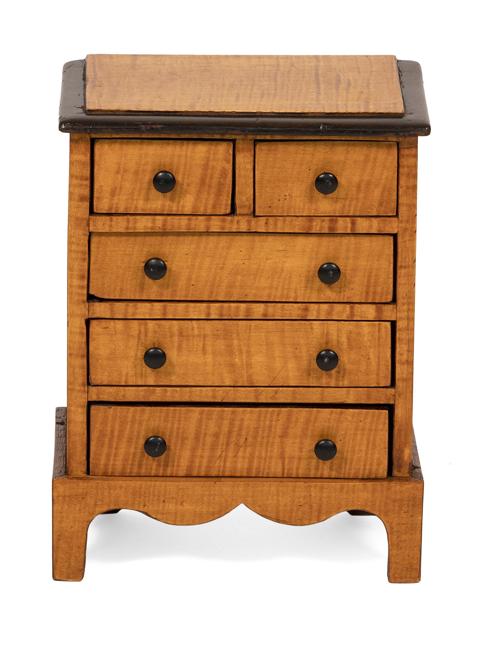 MINIATURE CHEST 19th Century Height 14”. Width 10.5”. Depth 6”.: MINIATURE CHEST 19th Century In tiger maple. Two side-by-side drawers over three full-width drawers and a shaped base. Height 14”. Width 10.5”. Depth 6”.