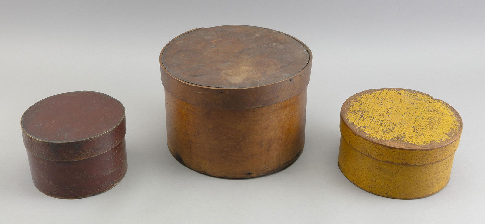 THREE ROUND WOODEN BOXES 19th Century Heights from 3.5” to 6.25”. Diameters from 6” (1 of 3)