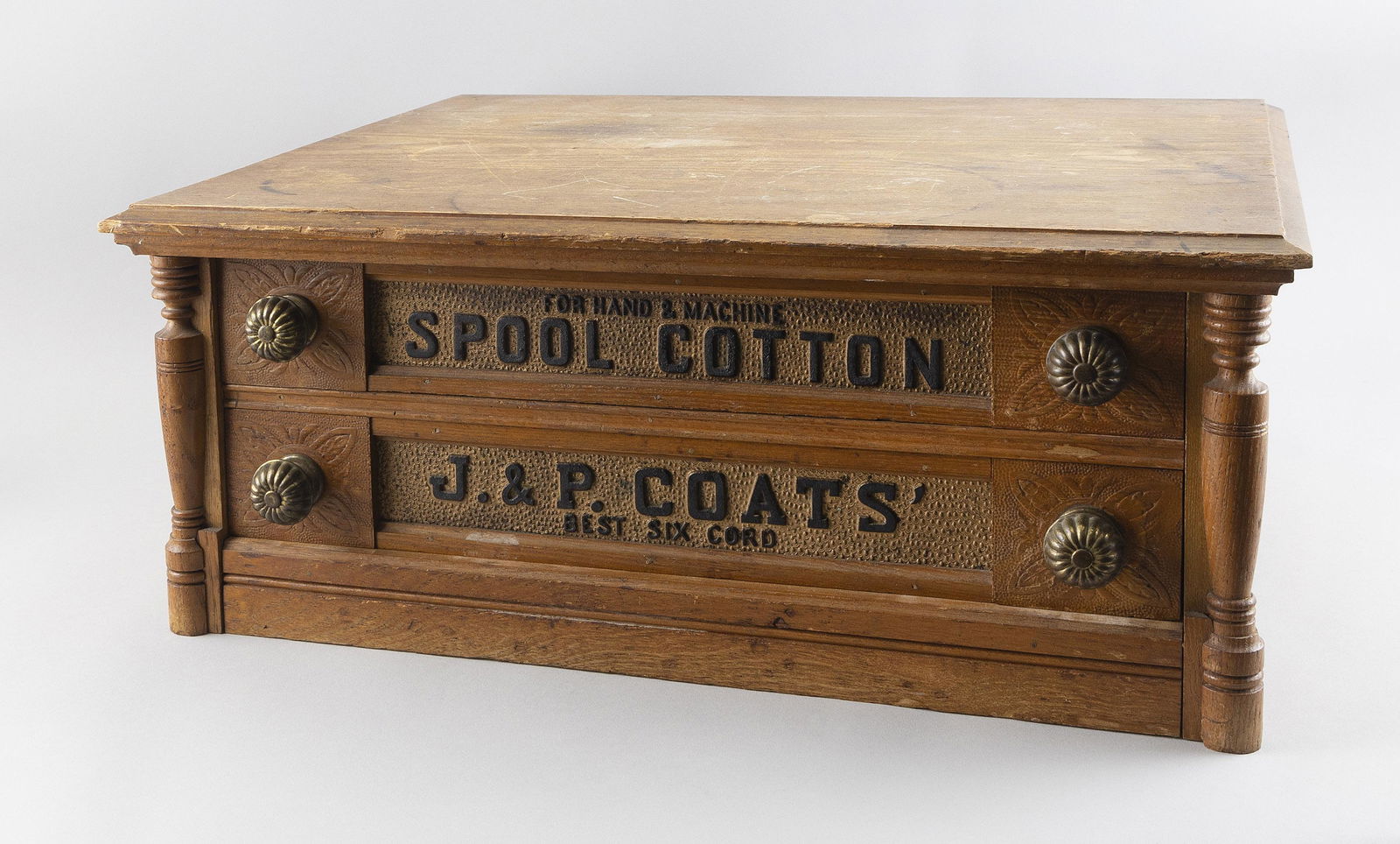 J. & P. COATS TWO-DRAWER SPOOL CABINET Early 20th Century Height 9”. Width 22.5”. Depth: J. & P. COATS TWO-DRAWER SPOOL CABINETEarly 20th CenturyIn oak. Drawers labeled.Height 9”. Width 22.5”. Depth 17”.