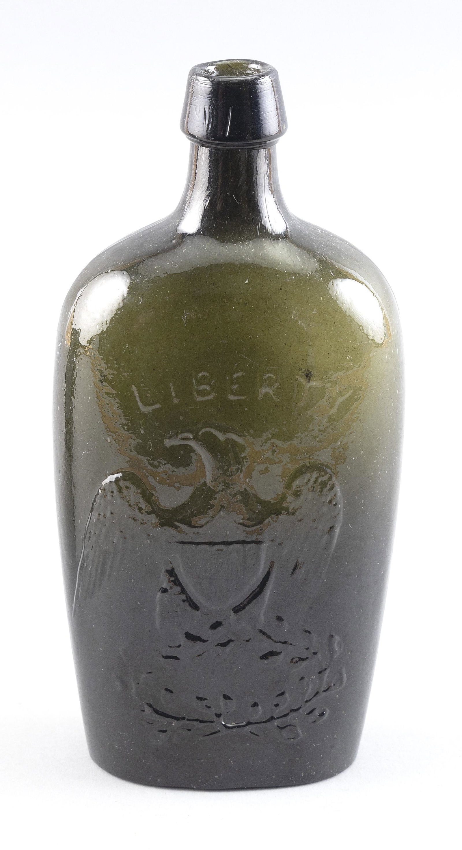 GII-62 EAGLE WILLINGTON HISTORICAL GLASS FLASK Circa 1850-1870 Height 7.75”.: GII-62 EAGLE WILLINGTON HISTORICAL GLASS FLASK Circa 1850-1870 In deep olive green. “Liberty” above the eagle on obverse. “Willington Glass Co., West Willington, Conn” on rever