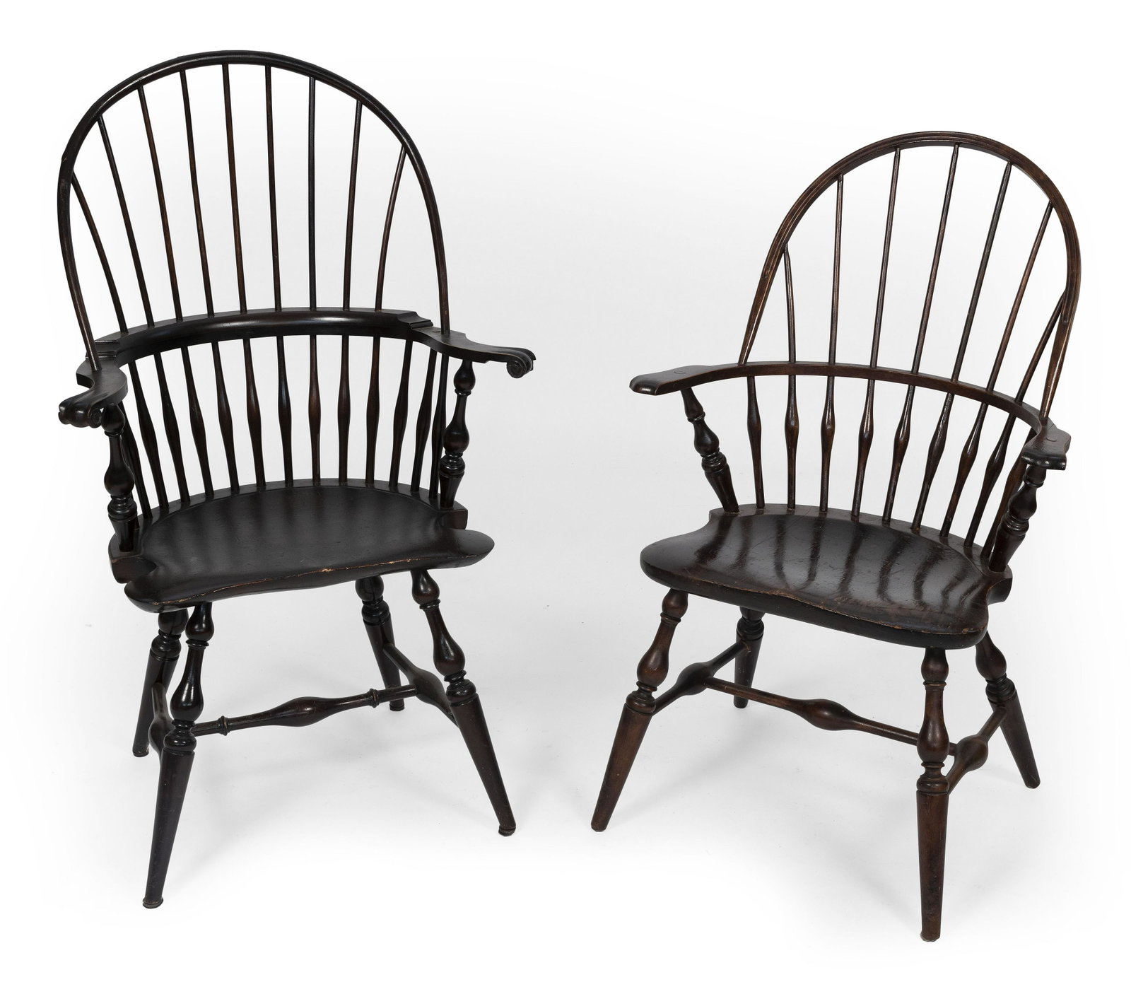 TWO WINDSOR ARMCHAIRS 20th Century Back heights 40” and 44.5”. Seat heights 18" and: TWO WINDSOR ARMCHAIRS 20th Century Hardwood under a dark finish. Back heights 40” and 44.5”. Seat heights 18" and 18.75”.