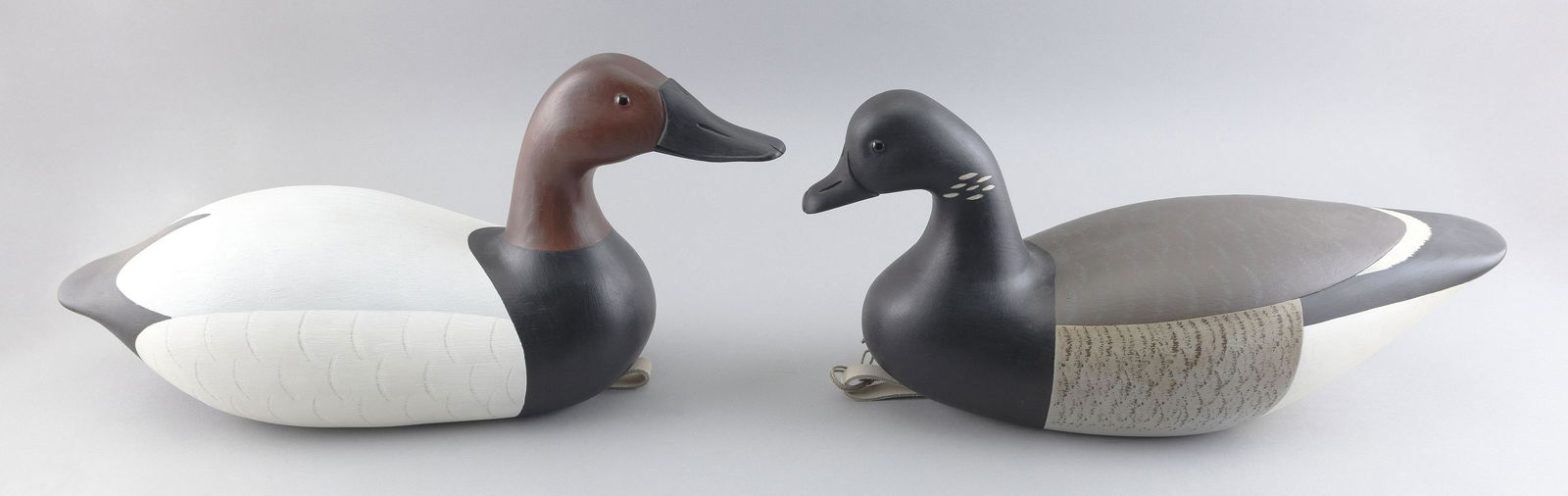 TWO GARY AVADANIAN DECOYS Reading, Massachusetts, 20th Century Lengths 19” and 21”.: TWO GARY AVADANIAN DECOYSReading, Massachusetts, 20th CenturyA brant and a canvasback. Both carved “GA”.Lengths 19” and 21”.