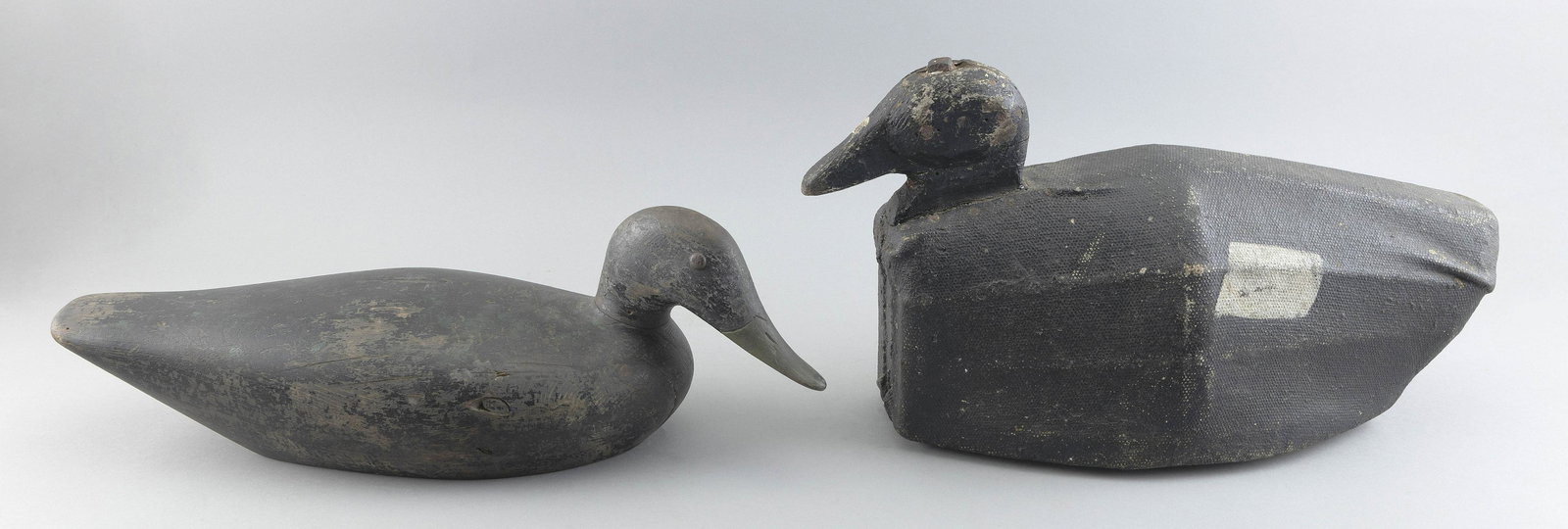 TWO DECOYS Early 20th Century Lengths 18” and 19”.: TWO DECOYSEarly 20th CenturyA New England scoter with canvas-covered body and a black duck by Whitney from Maine with tack eyes and turned head.Lengths 18” and 19”.
