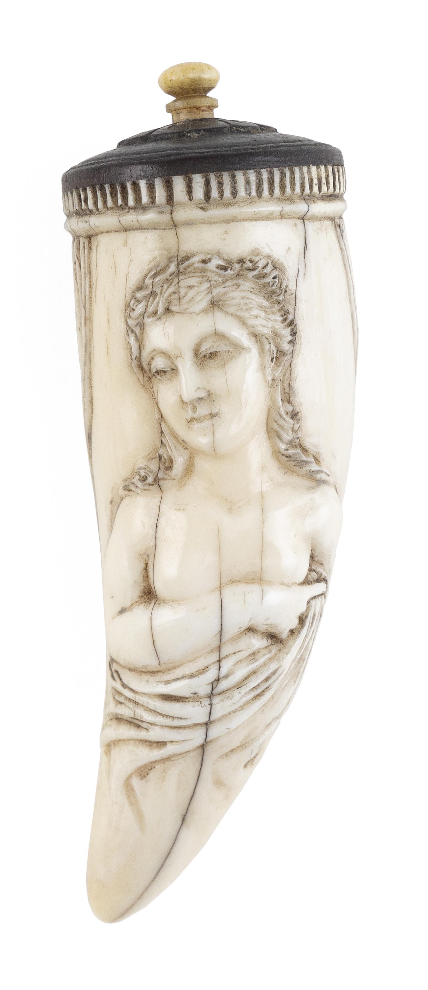 * RELIEF-CARVED WHALE'S TOOTH "JUNO" 20th Century Total length approx. 4".: * RELIEF-CARVED WHALE'S TOOTH "JUNO" 20th Century Obverse depicts the long-haired goddess draped in robes and set within swags. Identified in cartouche on reverse. Decorative carving at base