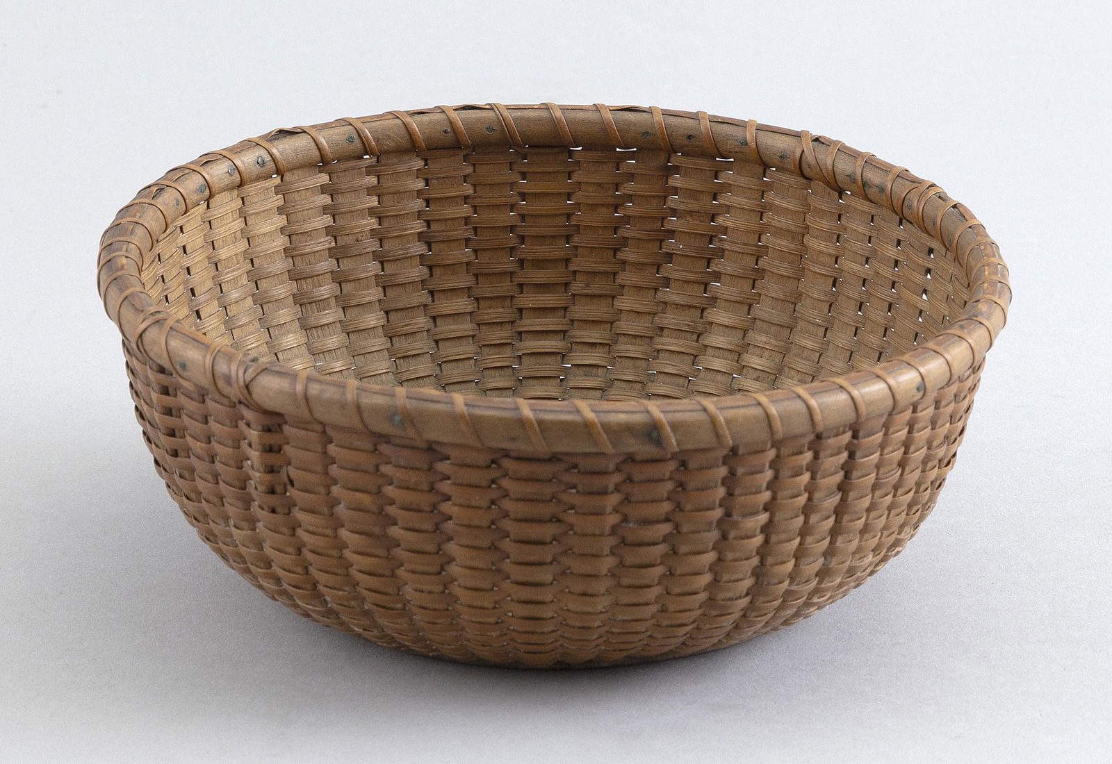ROUND NANTUCKET BASKET Early 20th Century Height 3”. Diameter 7.25”. (1 of 2)