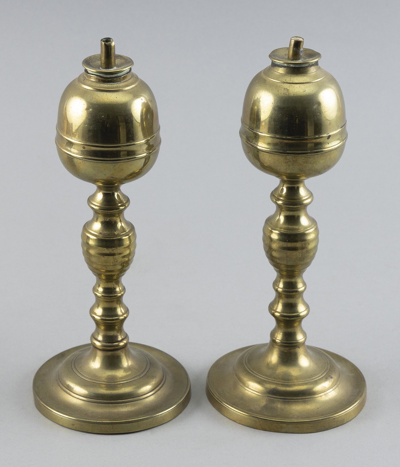 PAIR OF BRASS WHALE OIL LAMPS ATTRIBUTED TO WILLIAM WEBB OF WARREN, MAINE Circa 1830 Heights 8.75".: PAIR OF BRASS WHALE OIL LAMPS ATTRIBUTED TO WILLIAM WEBB OF WARREN, MAINE Circa 1830 Lemon-form fonts, ring-turned and beehive-ribbed shafts and footed bases. Similar to signed examples. Heights 8.75"