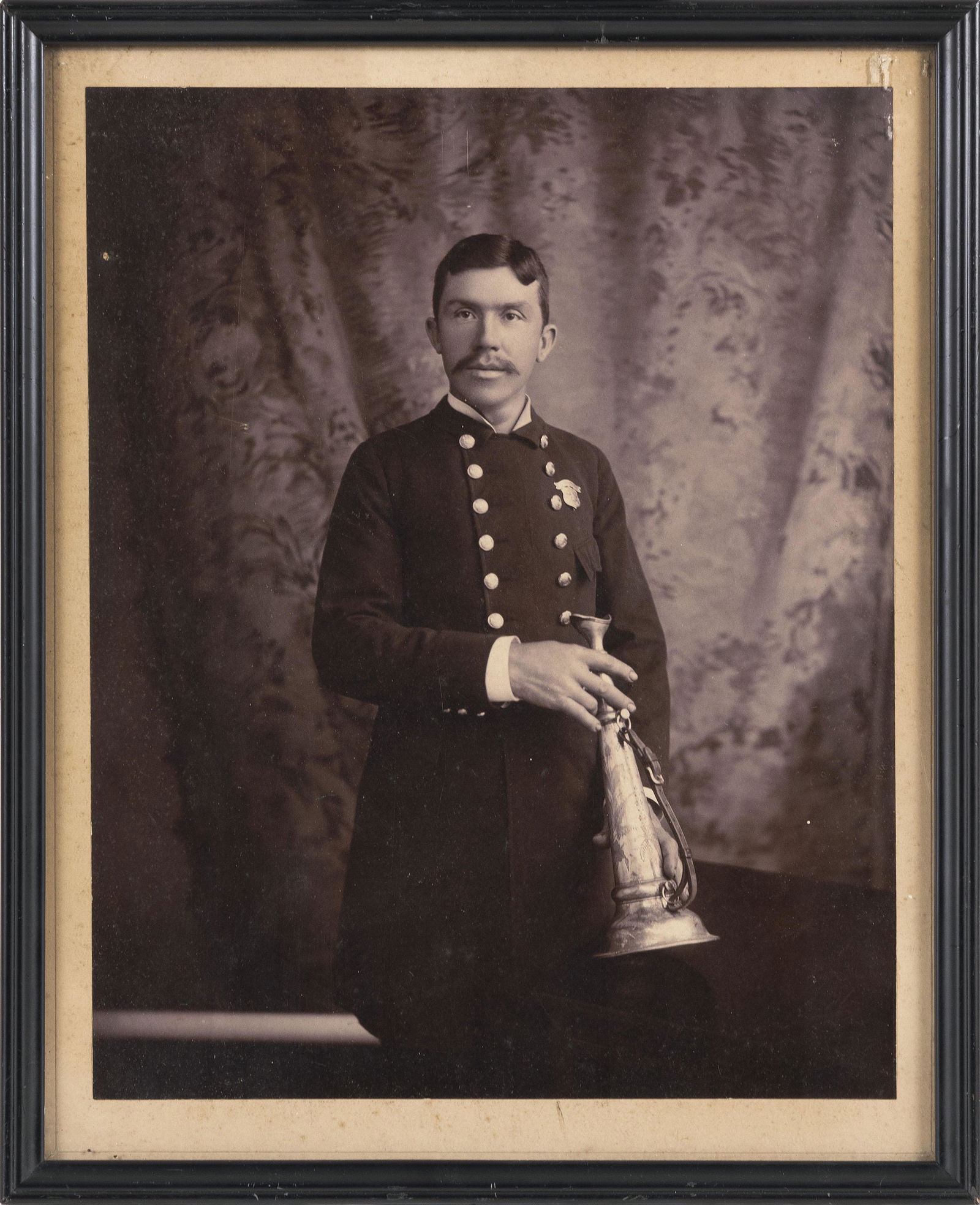 PHOTOGRAPH OF A FIREMAN HOLDING A FIRE TRUMPET 19th Century 13.25” x 10.5” sight. Framed (1 of 2)