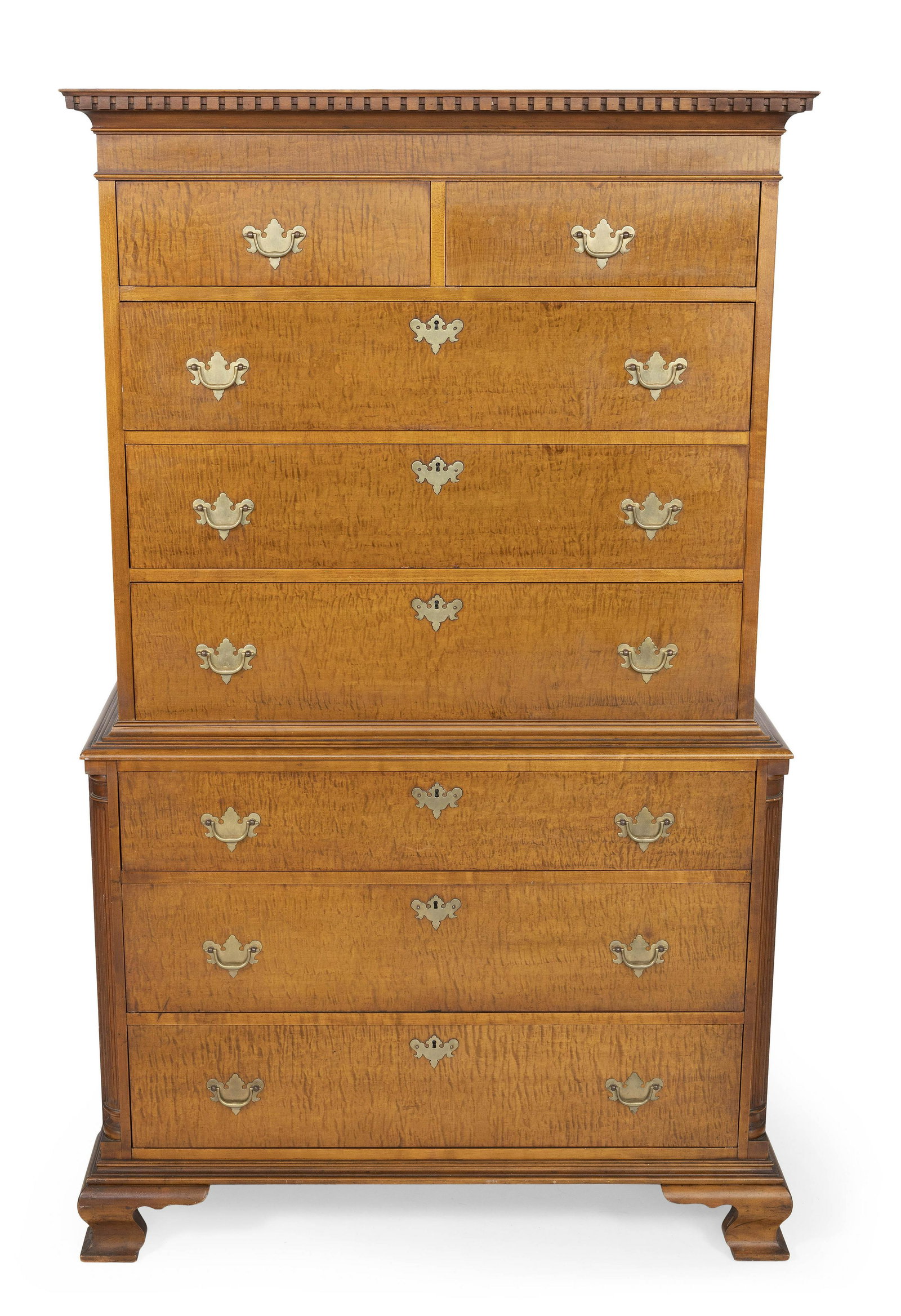 ONE-PART CHEST-ON-CHEST 20th Century Height 69”. Width 40”. Depth 21”.: ONE-PART CHEST-ON-CHEST20th CenturyIn maple and tiger maple veneer, with broken arch pediment, eight drawers and a shaped bracket base.Height 69”. Width 40”. Depth 21”.