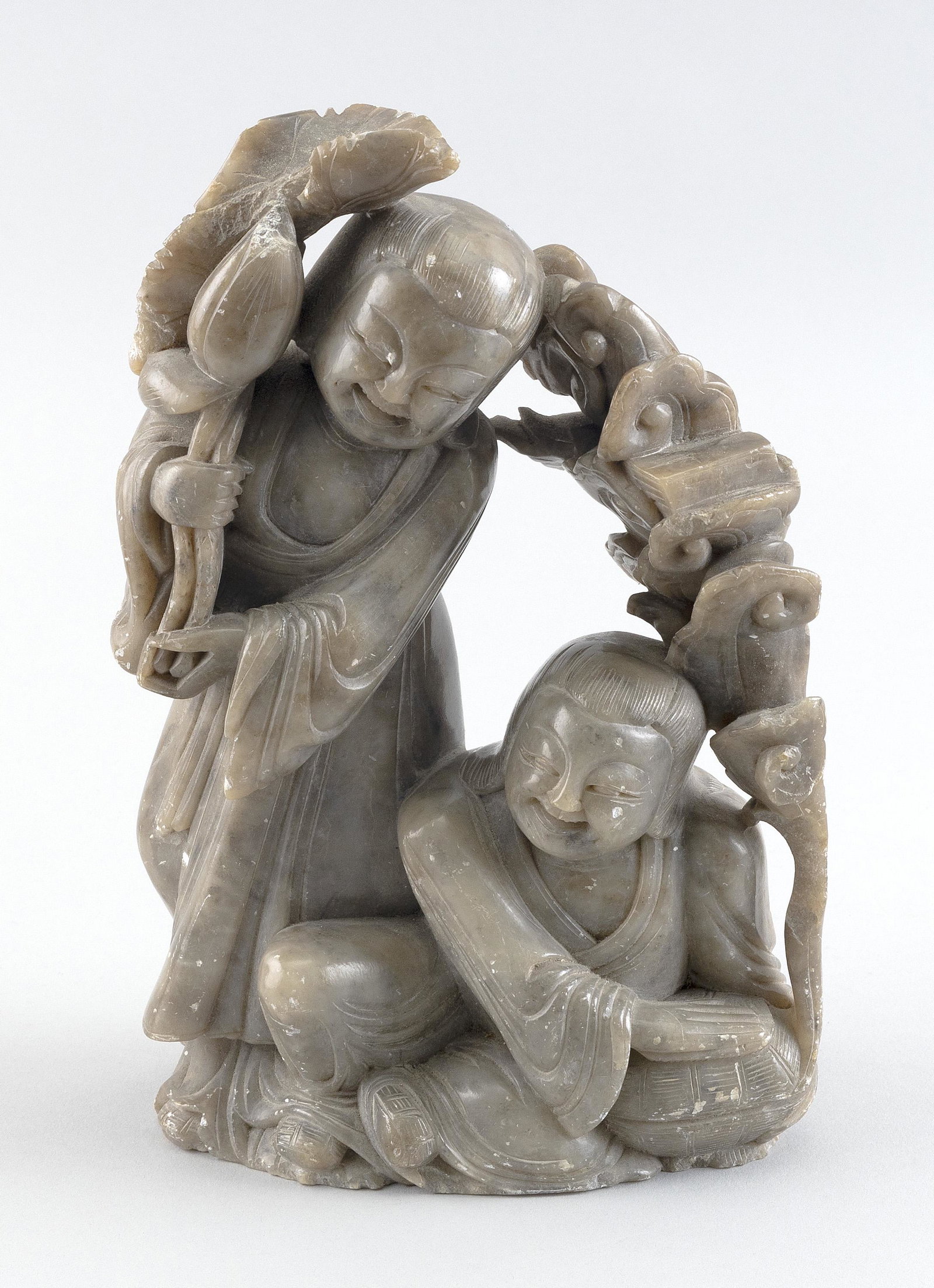 CHINESE CARVED HARDSTONE FIGURE GROUP Height 9". Length 6".: CHINESE CARVED HARDSTONE FIGURE GROUP A standing woman with a lotus staff and a seated woman with a garland of ruyi. Height 9". Length 6".