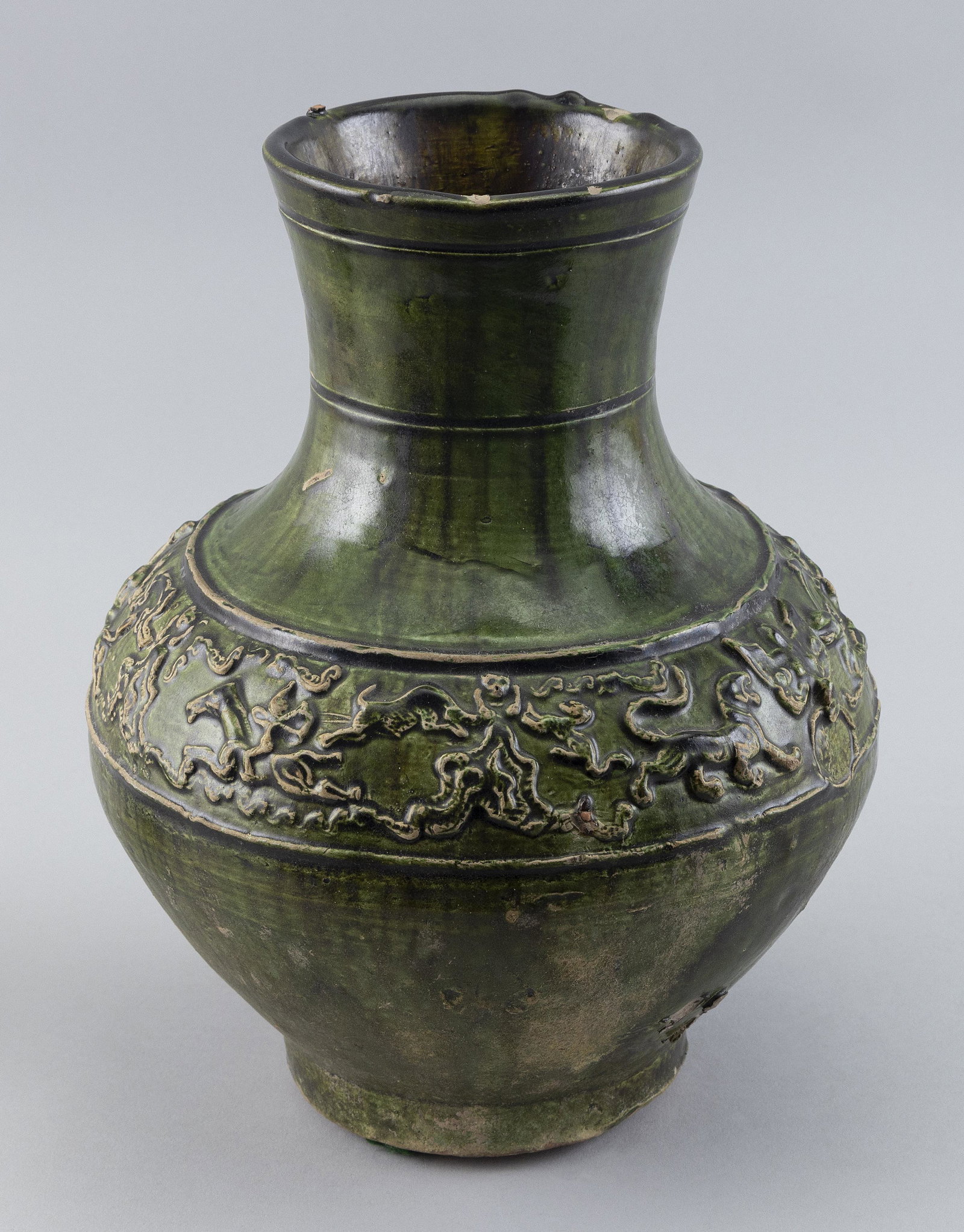 CHINESE GREEN GLAZE EARTHENWARE POTTERY FUNERARY VASE (HU) Han Dynasty Height 13".: CHINESE GREEN GLAZE EARTHENWARE POTTERY FUNERARY VASE (HU) Han Dynasty Ovoid body taotie and ring handles and raised banded decoration of animals and figures. Height 13".