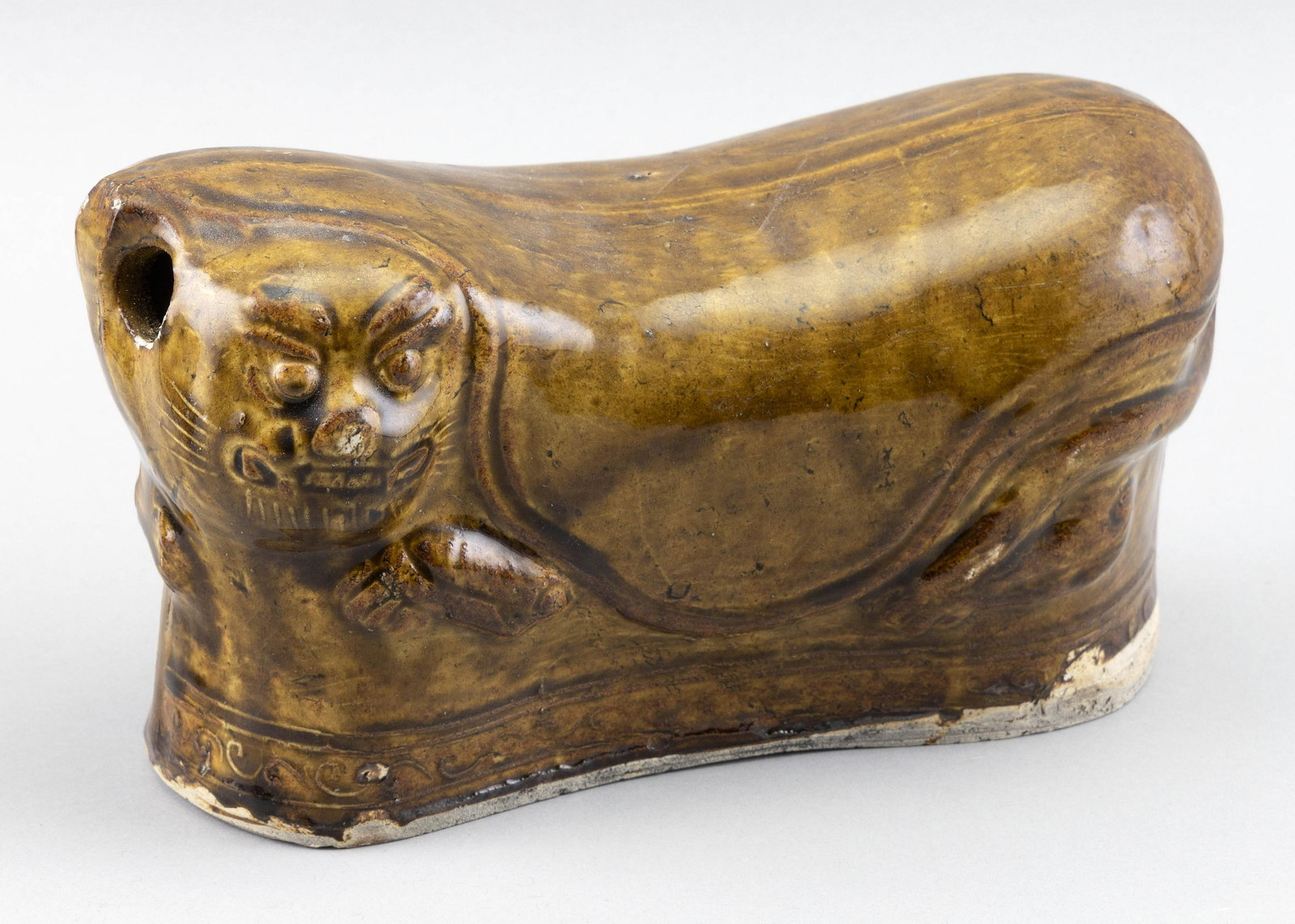 CHINESE BROWN GLAZE PORCELAIN PILLOW 19th Century Height 6”. Length 10”.: CHINESE BROWN GLAZE PORCELAIN PILLOW 19th Century In the form of a recumbent cat. Height 6”. Length 10”.