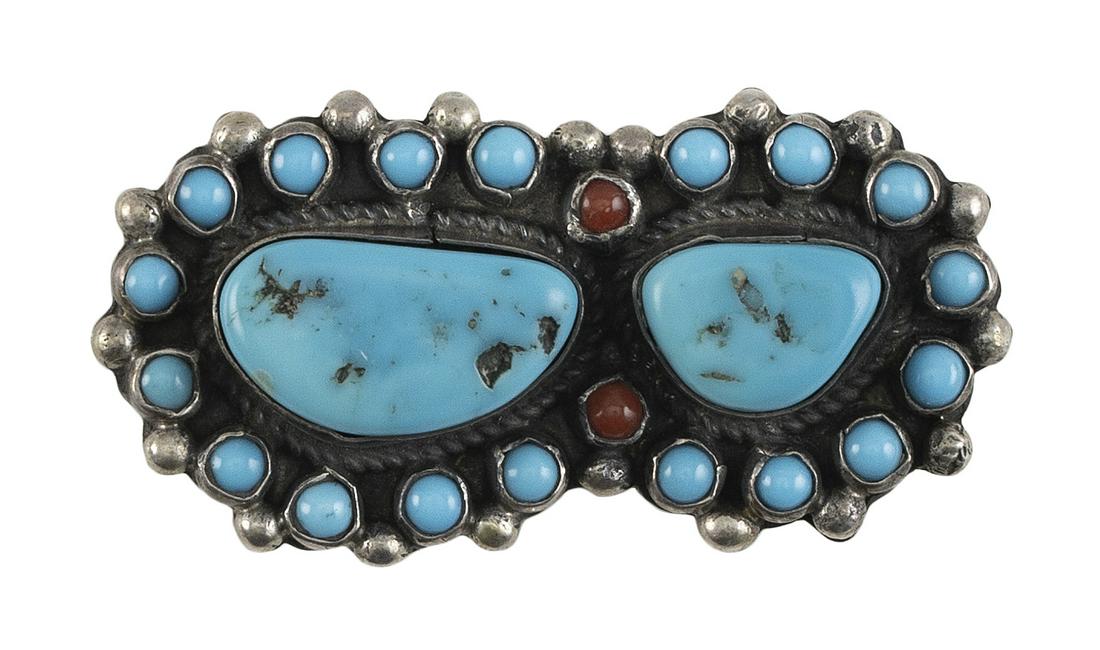 NAVAJO SILVER AND TURQUOISE "SNAKE EYE" PIN Mid-20th Century Approx. 11 total grams: NAVAJO SILVER AND TURQUOISE "SNAKE EYE" PIN Mid-20th Century Two central turquoise nuggets in high plain bezels surrounded by 18 turquoise and two coral "snake eyes". Gem-quality t