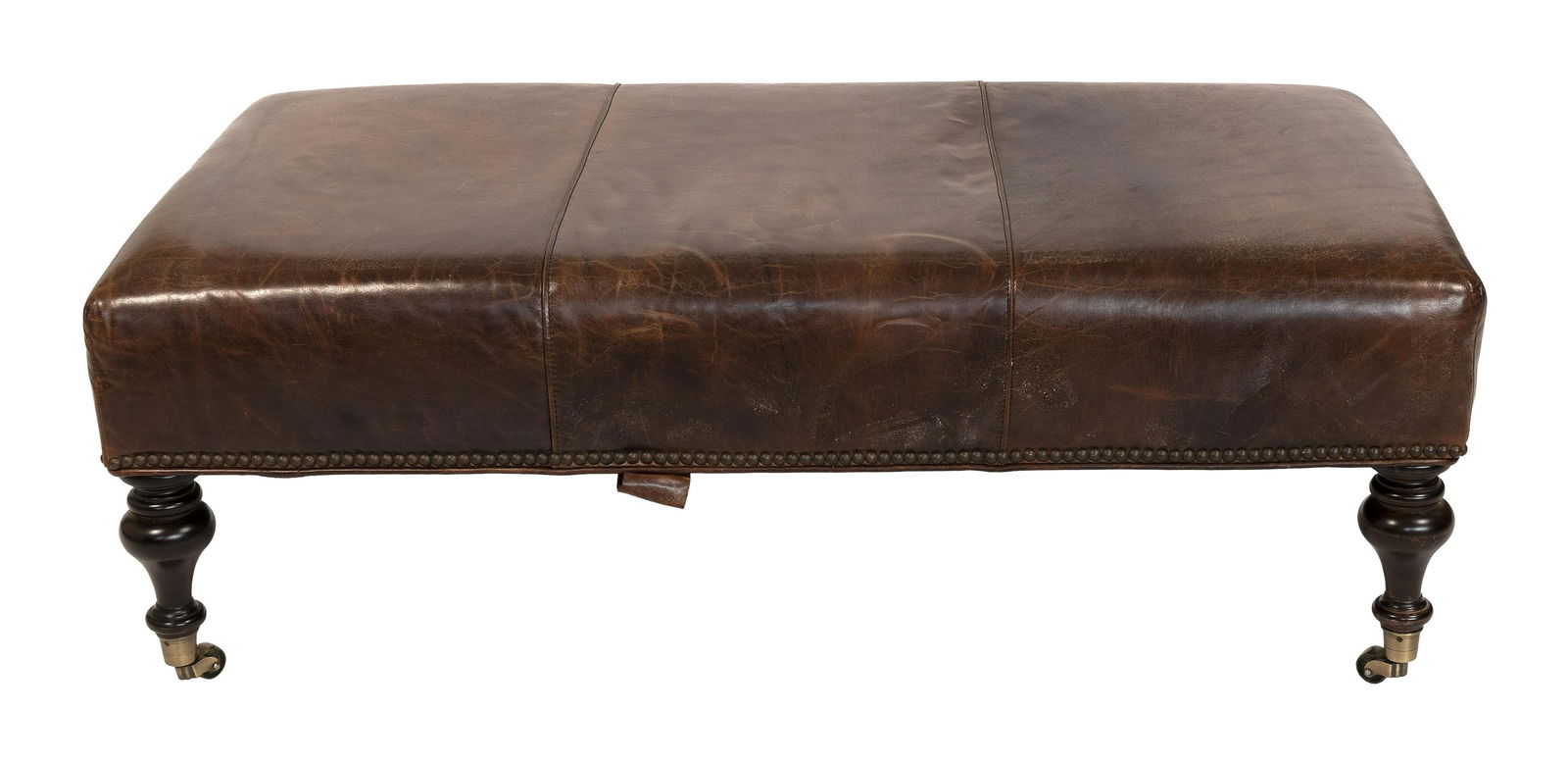 RESTORATION HARDWARE LEATHER OTTOMAN Contemporary Height 16.5”. Top 47” x 26.5”.: RESTORATION HARDWARE LEATHER OTTOMANContemporaryBrown leather upholstery with brass tacks. Turned hardwood legs fitted with brass casters.Height 16.5”. Top 47” x 26.5”.