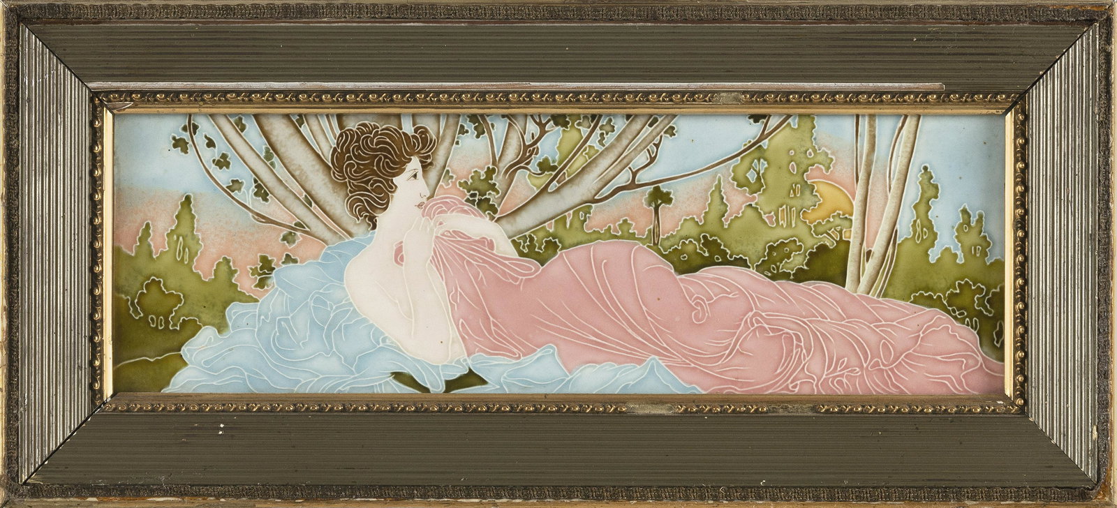 ART NOUVEAU MAJOLICA TILE PLAQUE BY EICHWALD Austria, Circa 1900 Tile 4.75” x 14.75”.: ART NOUVEAU MAJOLICA TILE PLAQUE BY EICHWALD Austria, Circa 1900 Depicts a woman wrapped in a pink blanket reclining in a green landscape under a setting sun. Signed on reverse â€œEichwald” 