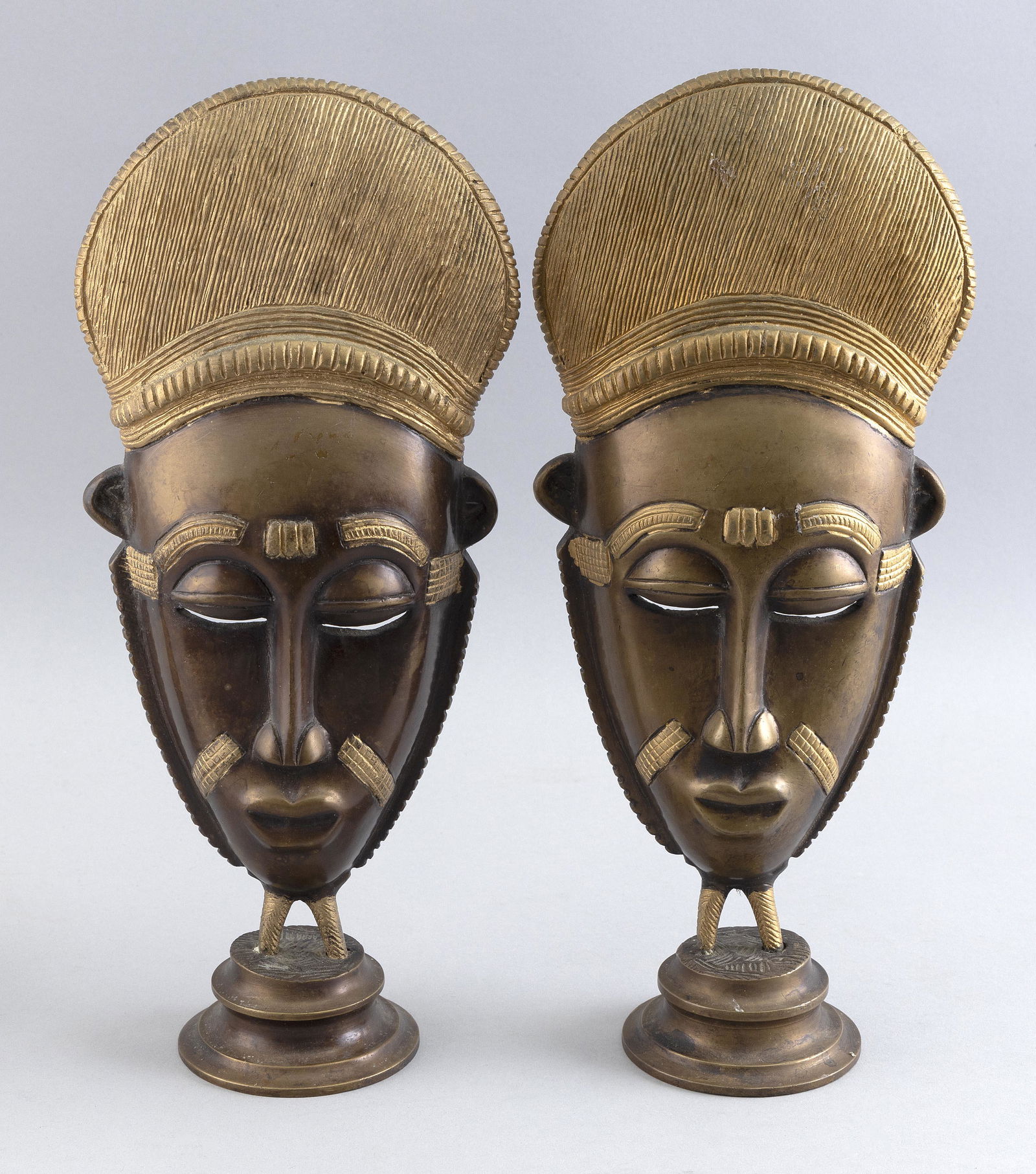 PAIR OF BRONZE SCULPTURES OF AFRICAN TRIBAL MASKS 20th Century Heights 14”. Widths 6”. (1 of 2)