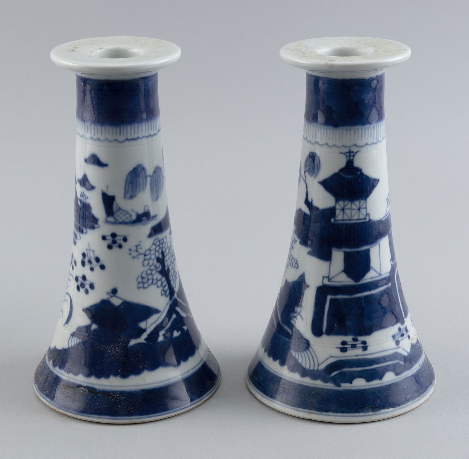 PAIR OF CHINESE EXPORT BLUE AND WHITE PORCELAIN CANDLESTICKS Early 20th Century Heights 8.5”. (1 of 2)