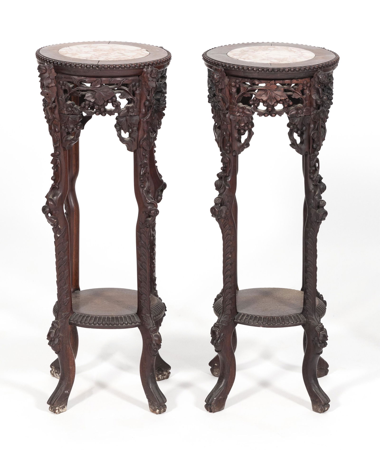 PAIR OF CHINESE CARVED ROSEWOOD STANDS Late 19th/Early 20th Century Heights 30". Diameters 11.5". (1 of 5)