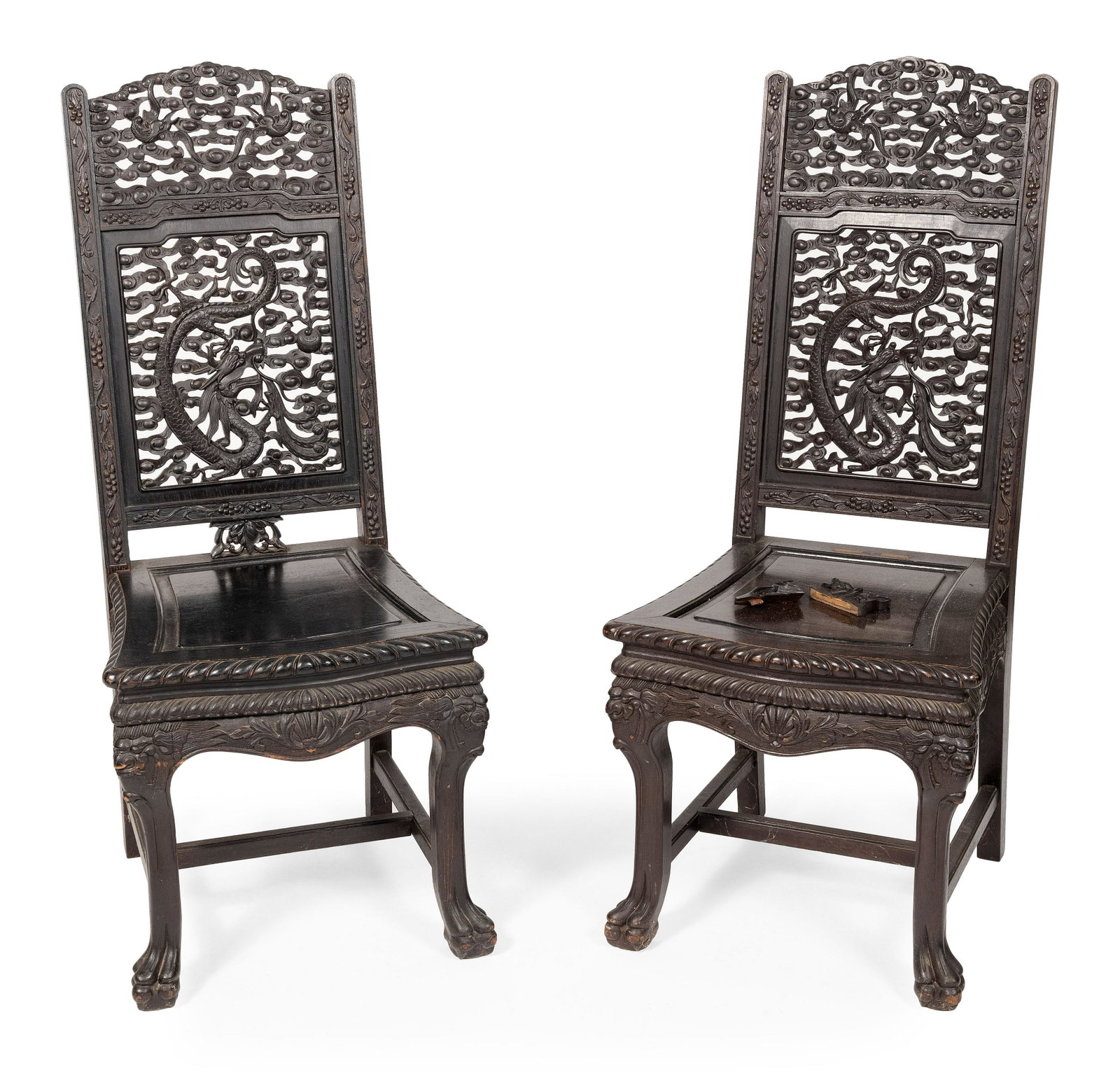 PAIR OF CHINESE CARVED ROSEWOOD SIDE CHAIRS Late 19th/Early 20th Century Back height 44". Seat: PAIR OF CHINESE CARVED ROSEWOOD SIDE CHAIRS Late 19th/Early 20th Century Backs with open-carved dragons and clouds. Legs joined with an H-stretcher and end in claw feet. Back height 44". Seat hei