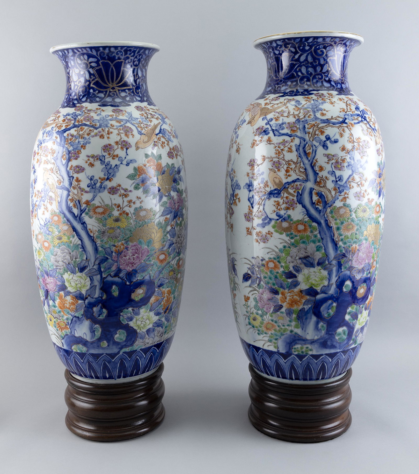 PAIR OF JAPANESE PORCELAIN TEMPLE VASES Late 19th Century Heights 25”. With turned wood bases. (1 of 2)