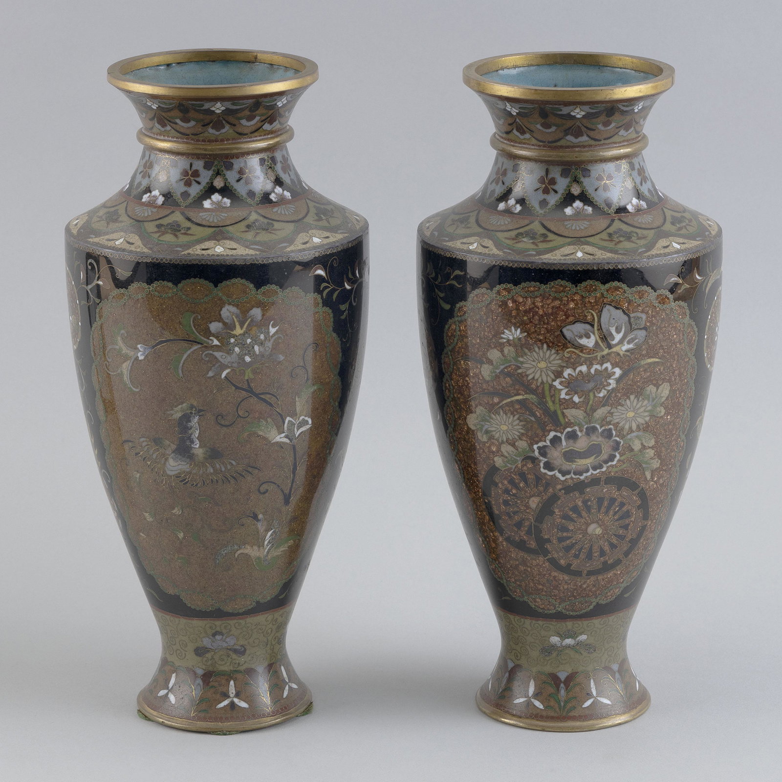 PAIR OF JAPANESE CLOISONNÉ ENAMEL BALUSTER VASES Late Meiji Period Heights 10”.: PAIR OF JAPANESE CLOISONNÃ‰ ENAMEL BALUSTER VASES Late Meiji Period Gilt floral, wheel and bird cartouches against a black ground. Heights 10”.