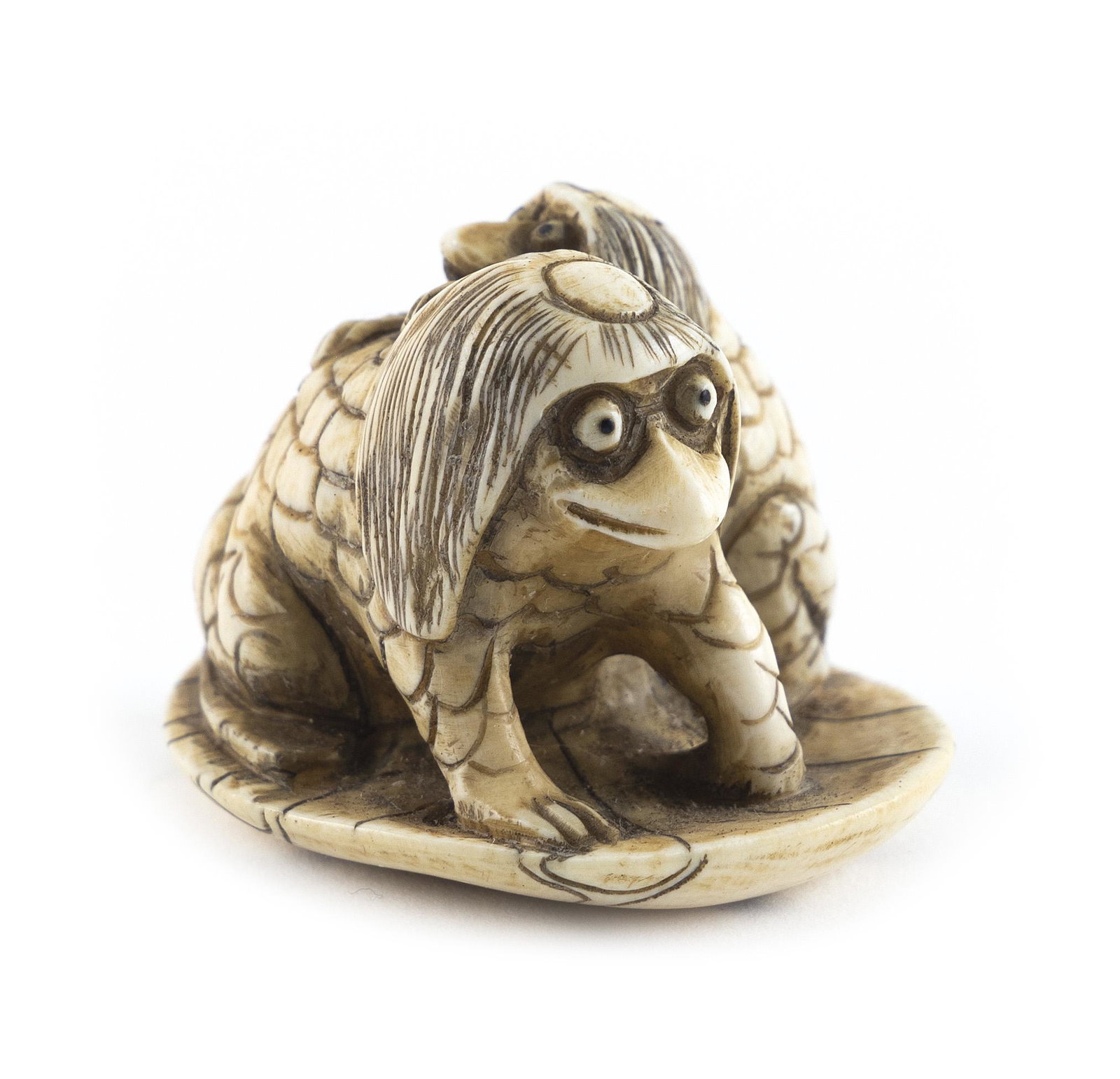 JAPANESE CARVED IVORY NETSUKE Late 19th Century Length 2”.: JAPANESE CARVED IVORY NETSUKE Late 19th Century A kappa and its young on a lotus leaf. Signed. Length 2”.