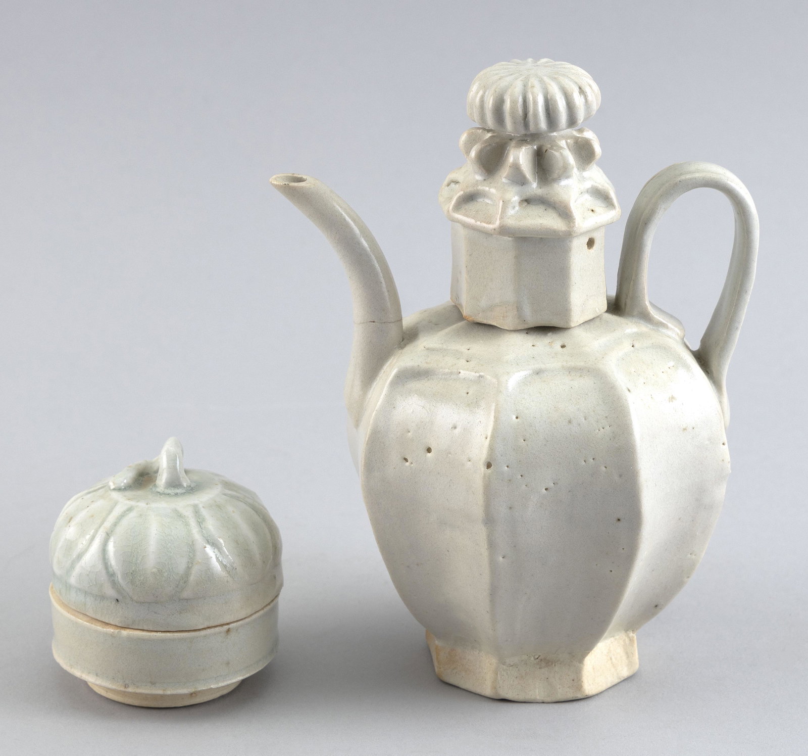 TWO PIECES OF CHINESE QINGBAI PORCELAIN 19th Century: TWO PIECES OF CHINESE QINGBAI PORCELAIN 19th Century 1) Wine ewer with ribbed ovoid body and a chrysanthemum-form knop on cover. Height 7”. 2) Covered lotus-form box. Height 3”.