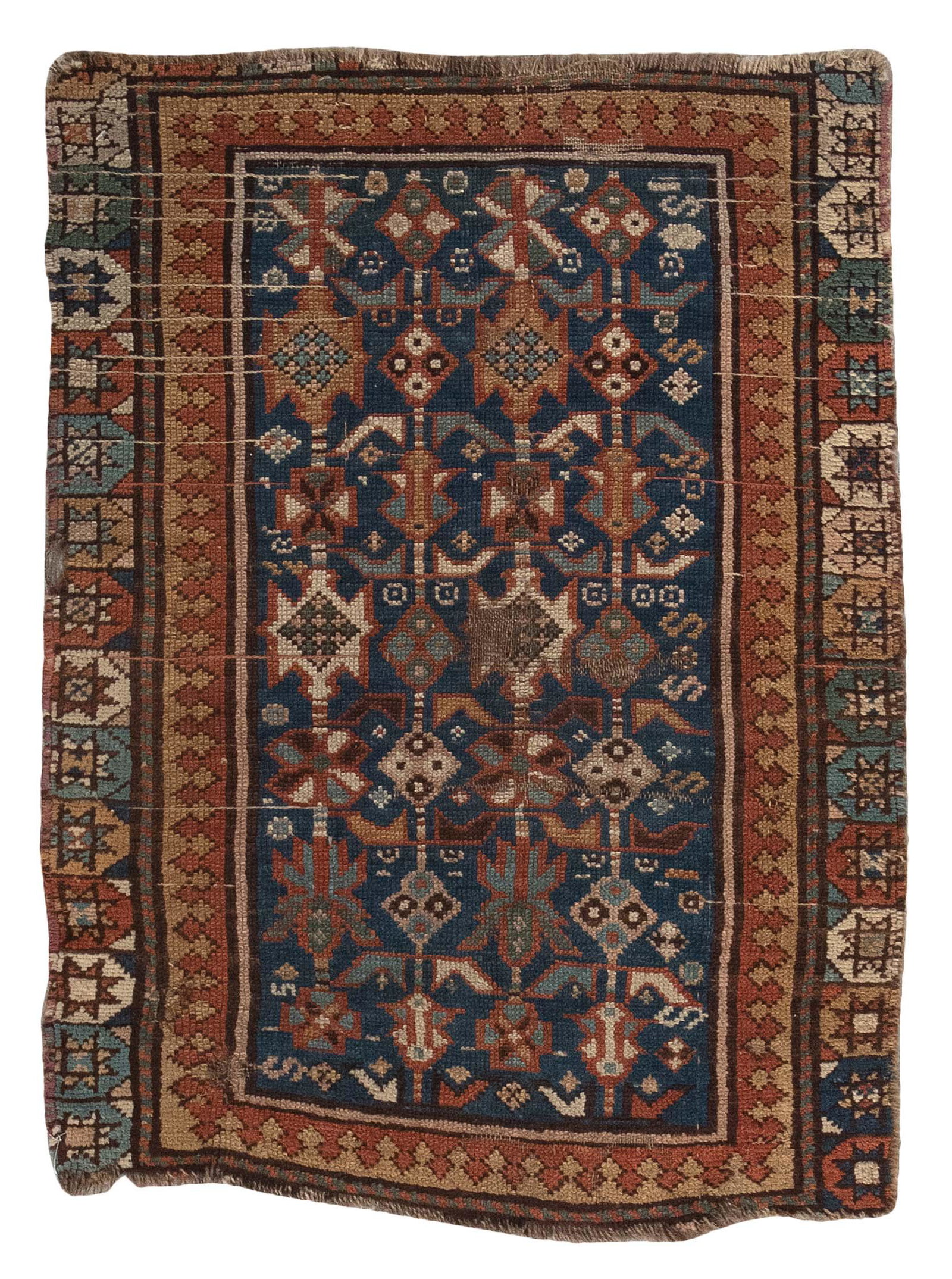 KAZAK MAT REMNANT: 2’3” X 3’3” Early 20th Century: KAZAK MAT REMNANT: 2’3” X 3’3” Early 20th Century Blue field with columns formed by blue, dark gold, rust red, tan and ivory stylized branches and blossoms. Gold and rust red i