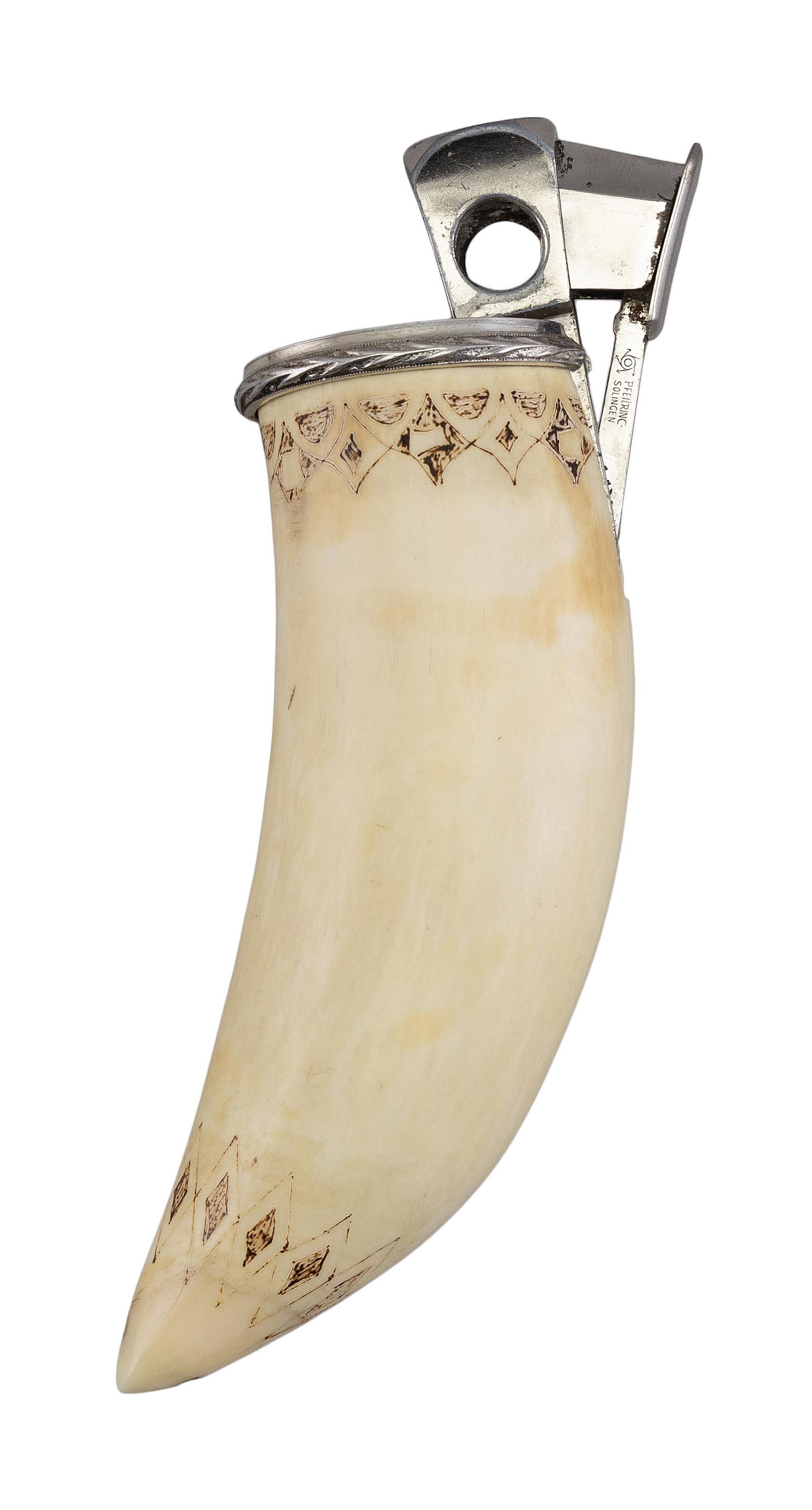 SCRIMSHAW WHALE TOOTH MOUNTED AS A CIGAR CUTTER Germany, Early 20th Century Length 6".: SCRIMSHAW WHALE TOOTH MOUNTED AS A CIGAR CUTTER Germany, Early 20th Century Decorative scrimshaw borders at the tip and base. Length 6";.