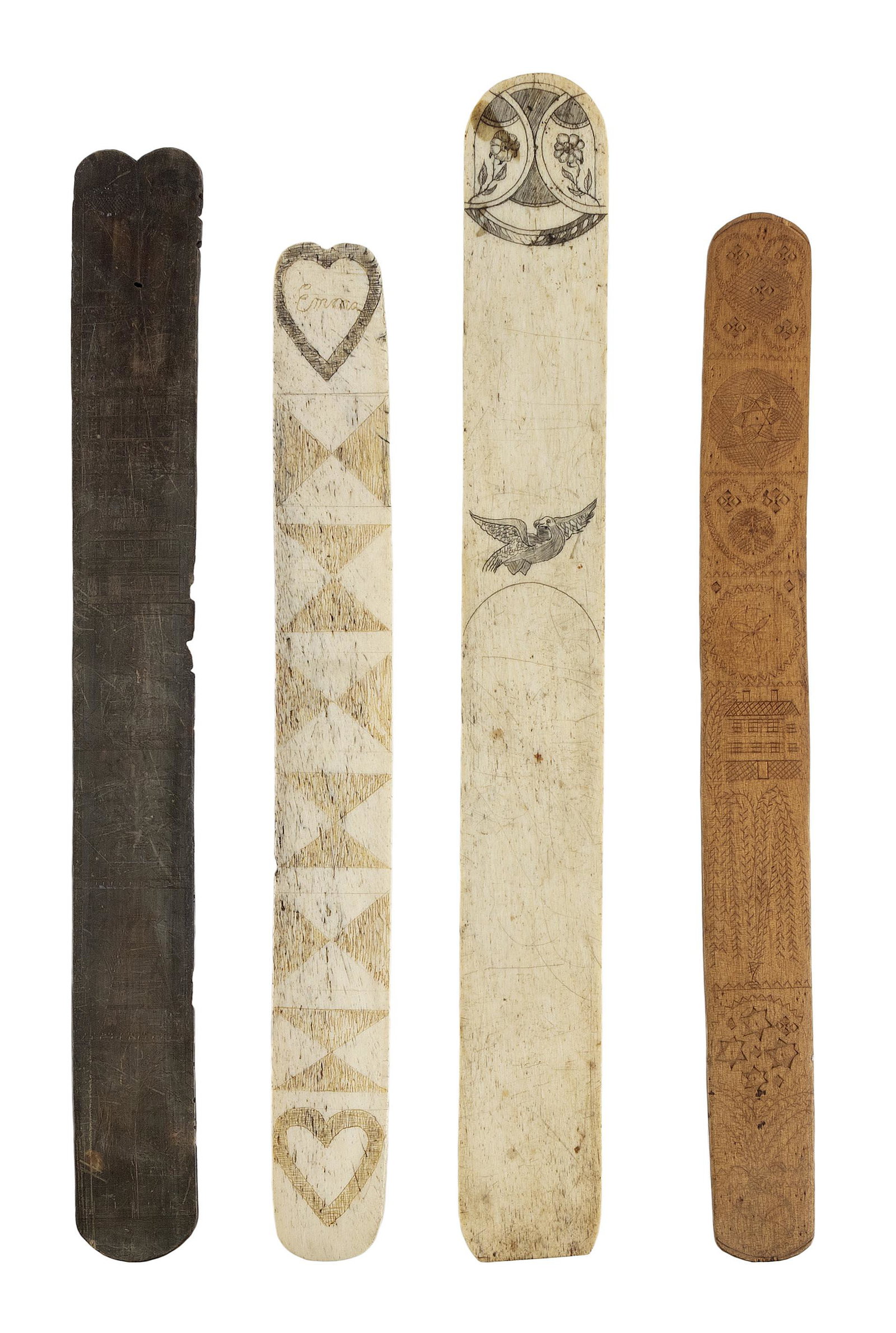 FOUR SCRIMSHAW BUSKS 19th Century: FOUR SCRIMSHAW BUSKS 19th Century 1) Whalebone, engraved with hearts and triangles, one heart containing ";Emma";. Length 12.25";. 2) Whalebone, engraved with a floral medallion and a bird. Length 14.