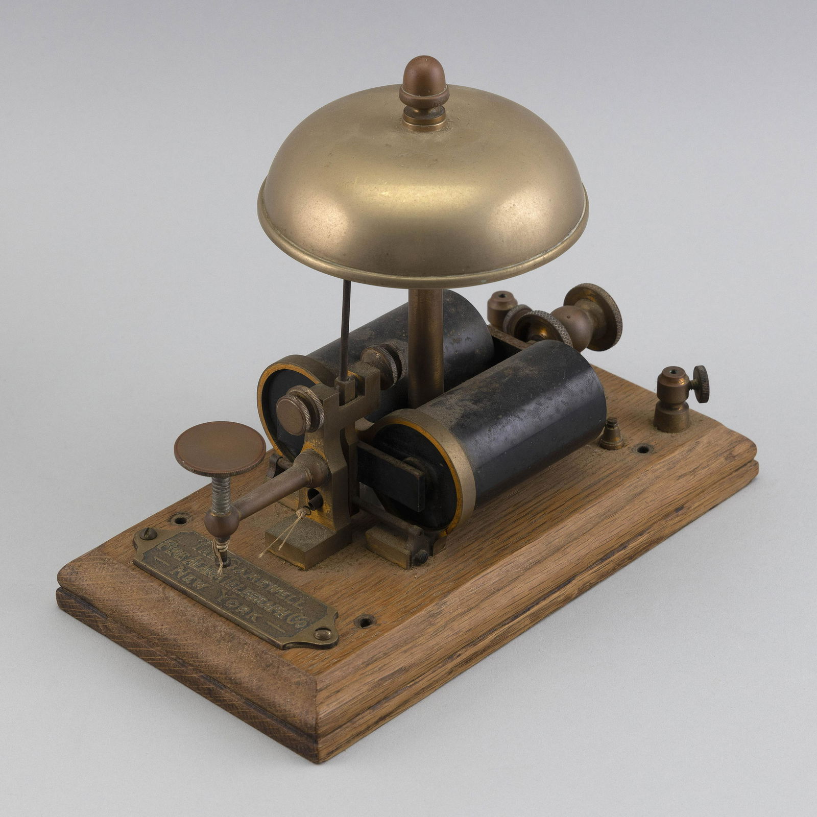 FIRE CHIEF'S DESKTOP TAPPER ALARM 19th Century Height 6”.: FIRE CHIEF'S DESKTOP TAPPER ALARM19th CenturyBrass alarm on an oak base. Brass “The Gamewell Fire Alarm Telegraph Co. New York” plaque mounted on base.Height 6”. Provenance:The Colle