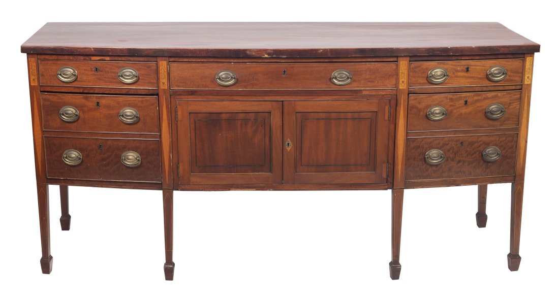 SWELL-FRONT SIDEBOARD England, Late 18th/Early 19th Century: SWELL-FRONT SIDEBOARD England, Late 18th/Early 19th Century In mahogany and mahogany veneer. Three side-by-side drawers over a central two-drawer cupboard flanked by three drawers, the right drawer si