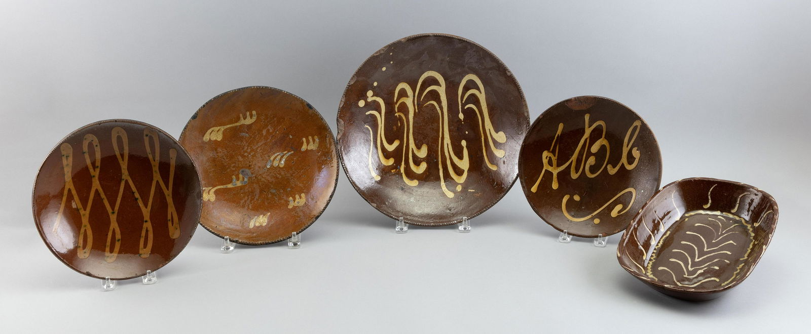 FIVE PIECES OF SLIP-DECORATED REDWARE 19th/20th Century Diameters from 9î to 12.5î. (1 of 2)