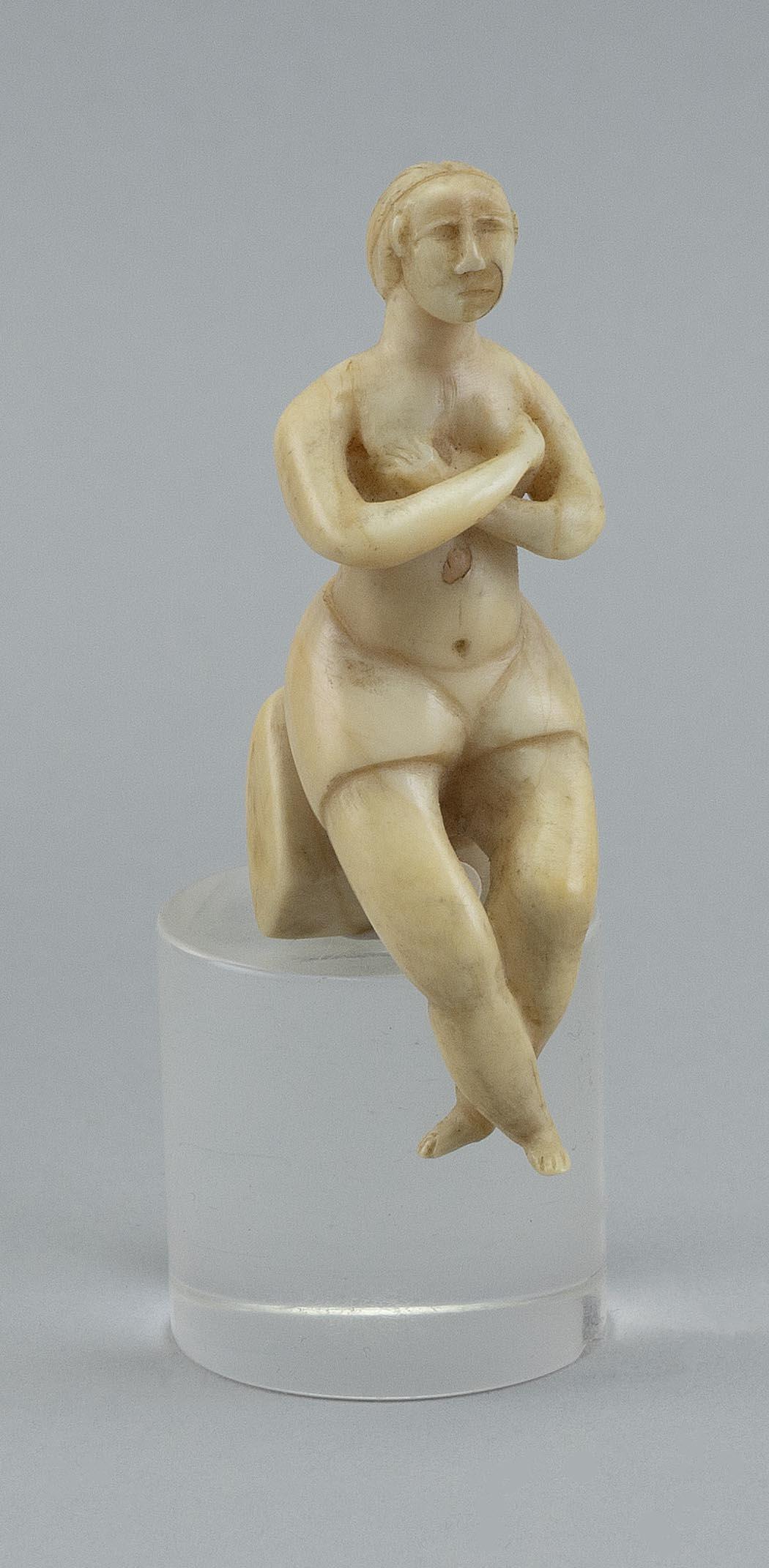 WHALE IVORY CARVING OF A SEATED FIGURE Late 19th/Early 20th Century Height 3.25î.: WHALE IVORY CARVING OF A SEATED FIGURE Late 19th/Early 20th Century Figure with a long braid and crossed arms and legs. Contained in a box with a note on lid ìCapt Nyeís granddaughter 1908 C