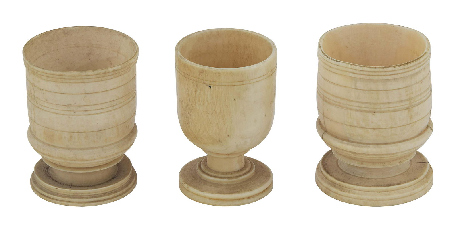 THREE EGG CUPS 19th Century Heights approx. 2.25î.: THREE EGG CUPS19th CenturyIncludes a whale ivory pair with fine incised bandings.Heights approx. 2.25î.