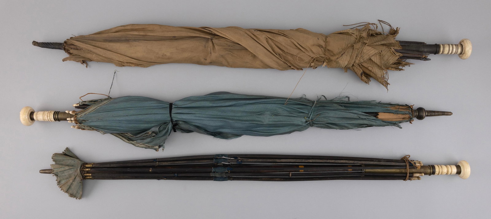 THREE ANTIQUE UMBRELLAS 19th Century Lengths from 37.5î to 38.25î.: THREE ANTIQUE UMBRELLAS 19th Century All with turned bone handles and baleen ribs. Lengths from 37.5î to 38.25î. Provenance: The Estate of Paul and Diane Madden, Sandwich, Massachusetts.
