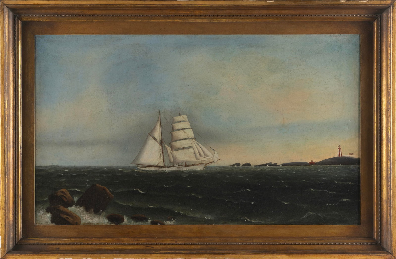 AMERICAN SCHOOL (Early 20th Century,), A white-hulled brigantine off a lighthouse., Oil on canvas,: AMERICAN SCHOOL Early 20th Century A white-hulled brigantine off a lighthouse. Unsigned. Oil on canvas, 20" x 35". Framed 27" x 42".