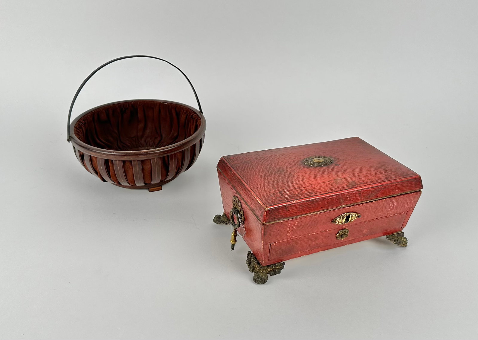 SEWING BOX AND BASKET Sewing box height 4". Width 8". Depth 5". Basket height 3.5". Diameter 7.25".: SEWING BOX AND BASKET Circa 1820 box under a red finish. Interior of lid with a Thos. Lund, London print of a bird. Full-width drawer below sewing compartment. Brass feet and side handles. Includes ke
