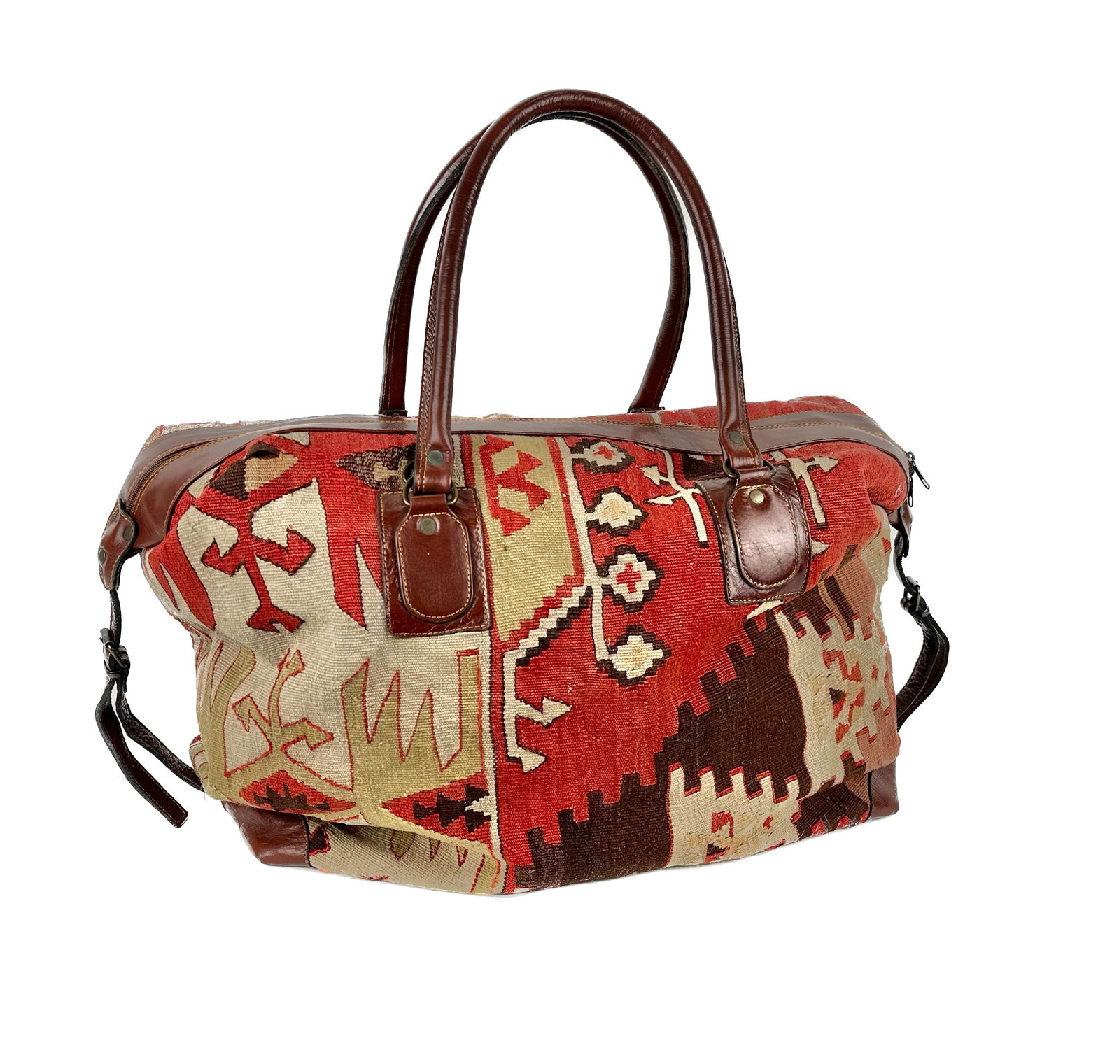 KILIM CARPET SATCHEL BAG 20th Century Height approx. 14". Width 26".: KILIM CARPET SATCHEL BAG 20th Century Zippered bag with leather trim, the Kilim in red, cream and brown. Height approx. 14". Width 26".