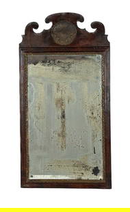 QUEEN ANNE MIRROR Mid-18th Century Height 27.25". Width 14".: QUEEN ANNE MIRRORMid-18th CenturyWalnut veneer frame with parcel gilt liner and carved medallion in crest. Early mirror glass. Original backboards.Height 27.25". Width 14".