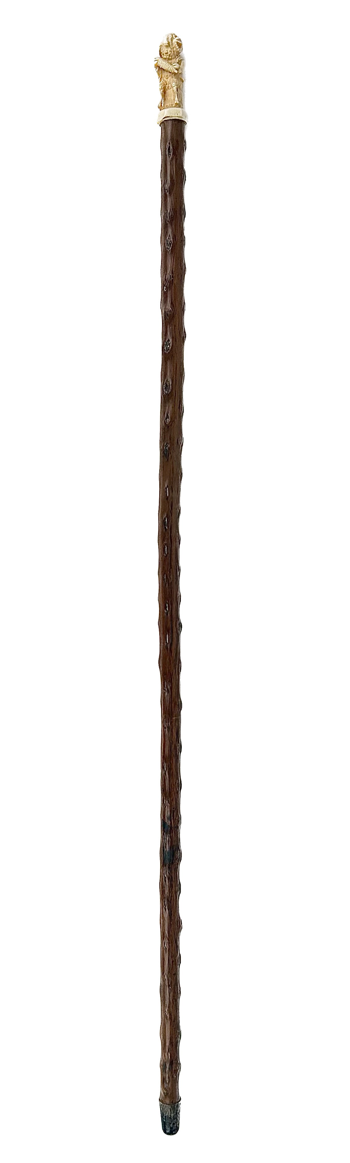 CANE WITH INTERESTING RAM HANDLE Late 19th/Early 20th Century Length 35.25".: CANE WITH INTERESTING RAM HANDLE Late 19th/Early 20th Century Ivory handle carved as a ram wearing a cutaway coat and holding a bobbin of wool while seated on a plinth engraved with shields containing