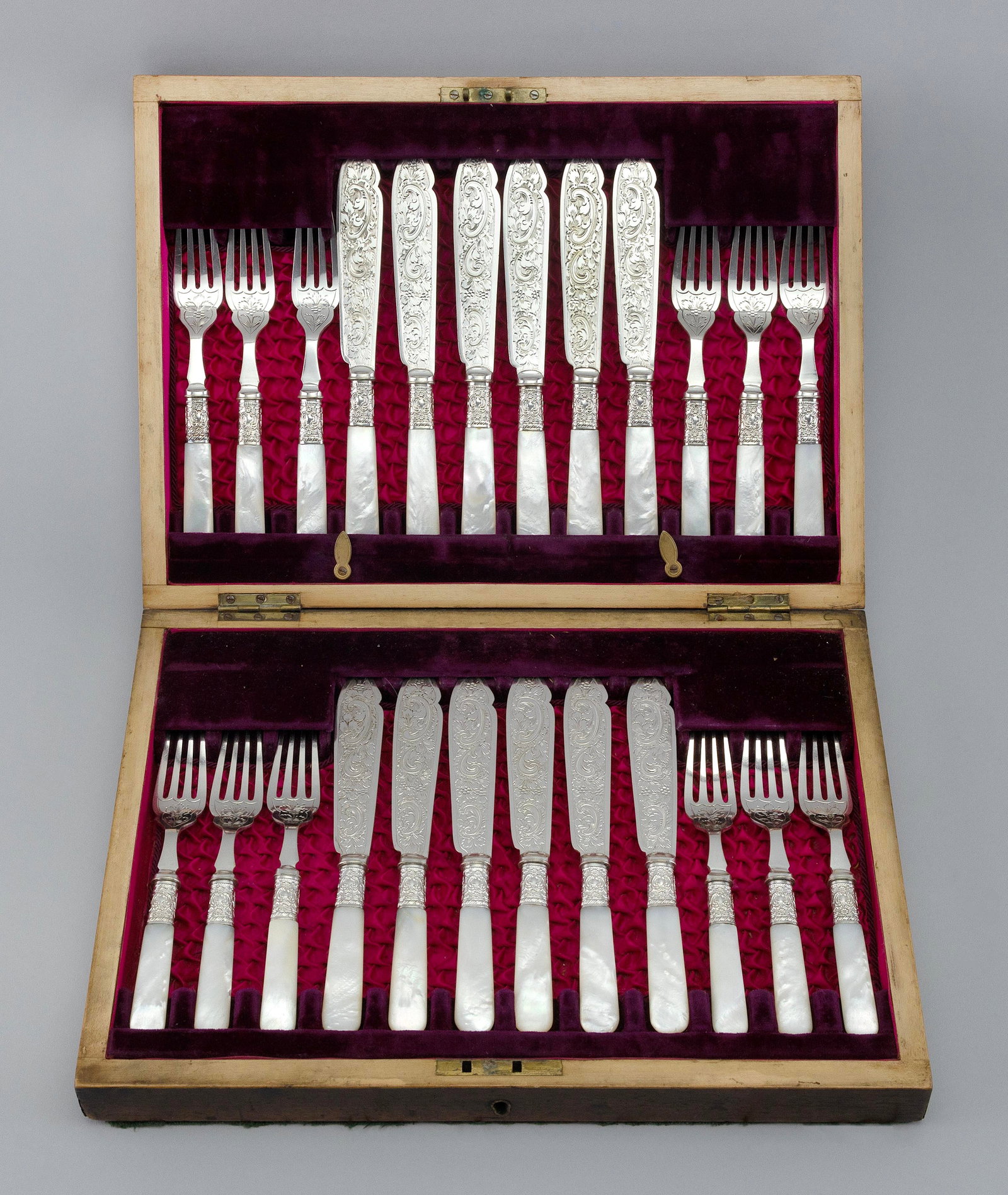 SILVER PLATED AND MOTHER-OF-PEARL FISH SERVICE FOR TWELVE England, Late 19th Century: SILVER PLATED AND MOTHER-OF-PEARL FISH SERVICE FOR TWELVE England, Late 19th Century All pieces with ornate engraving. Makerís mark ìR.P.". Retains original fitted presentation case. Case he