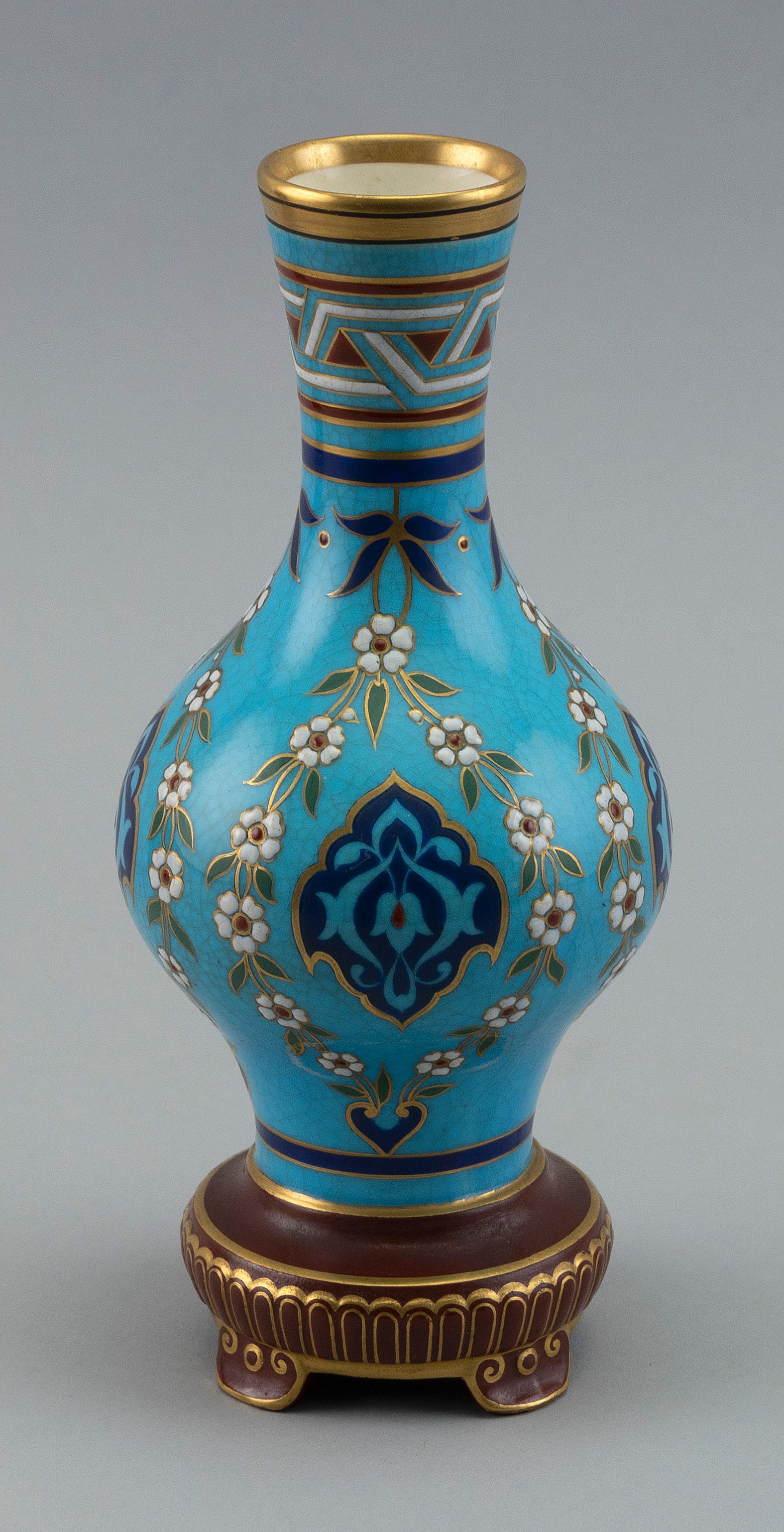 MINTON PSEUDO-CLOISONNÃ‰ CELESTE BLUE VASE England, 19th Century Height 8î.: MINTON PSEUDO-CLOISONNÃ‰ CELESTE BLUE VASE England, 19th Century Decoration of flowers and lappets on a blue ground. Height 8Ã®.
