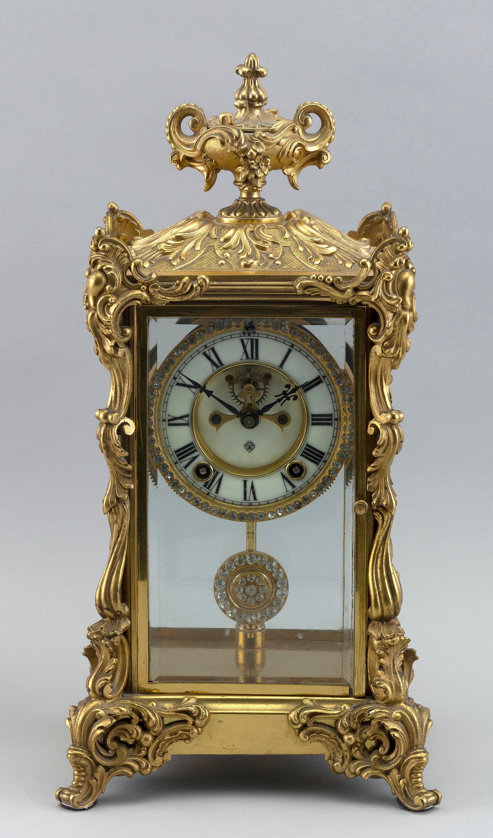 ANSONIA GILT METAL SHELF CLOCK New York, Late 19th Century Height 16". Width 8". Depth 7". (1 of 2)