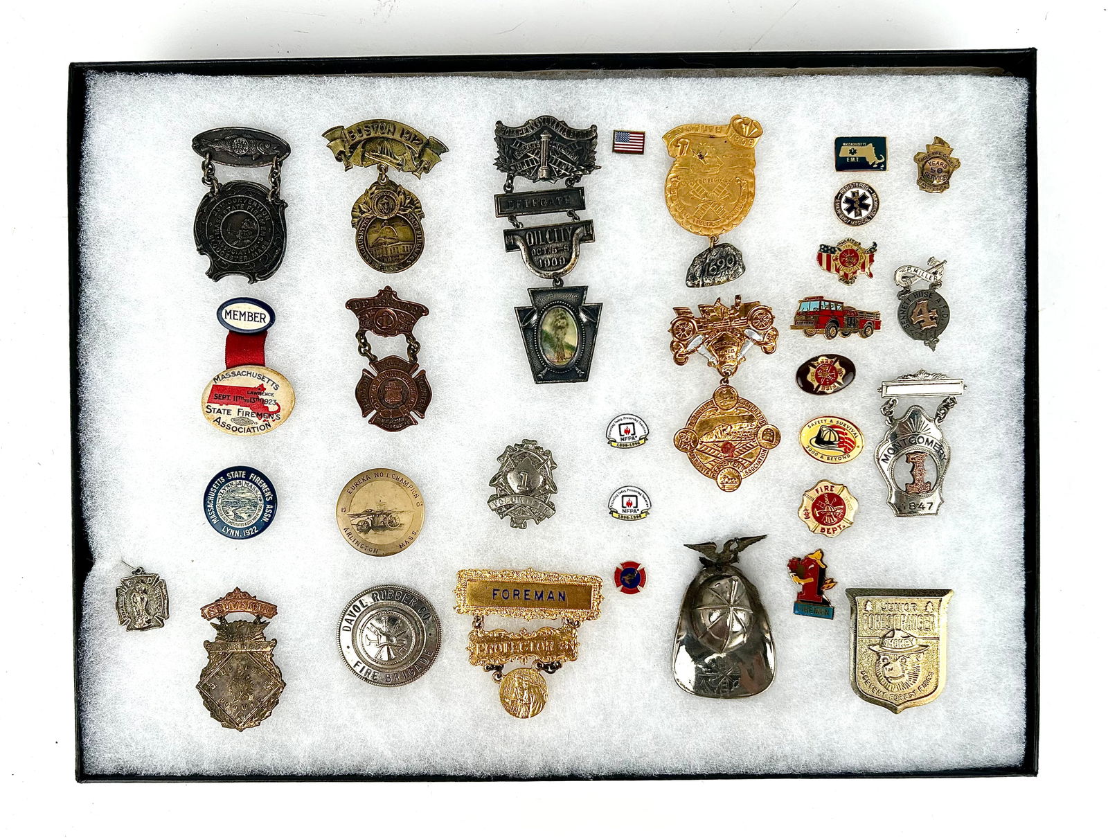 CASED COLLECTION OF TWENTY-EIGHT FIRE CONVENTION BADGES AND PINBACKS 20th Century Case 12" x 16". (1 of 5)