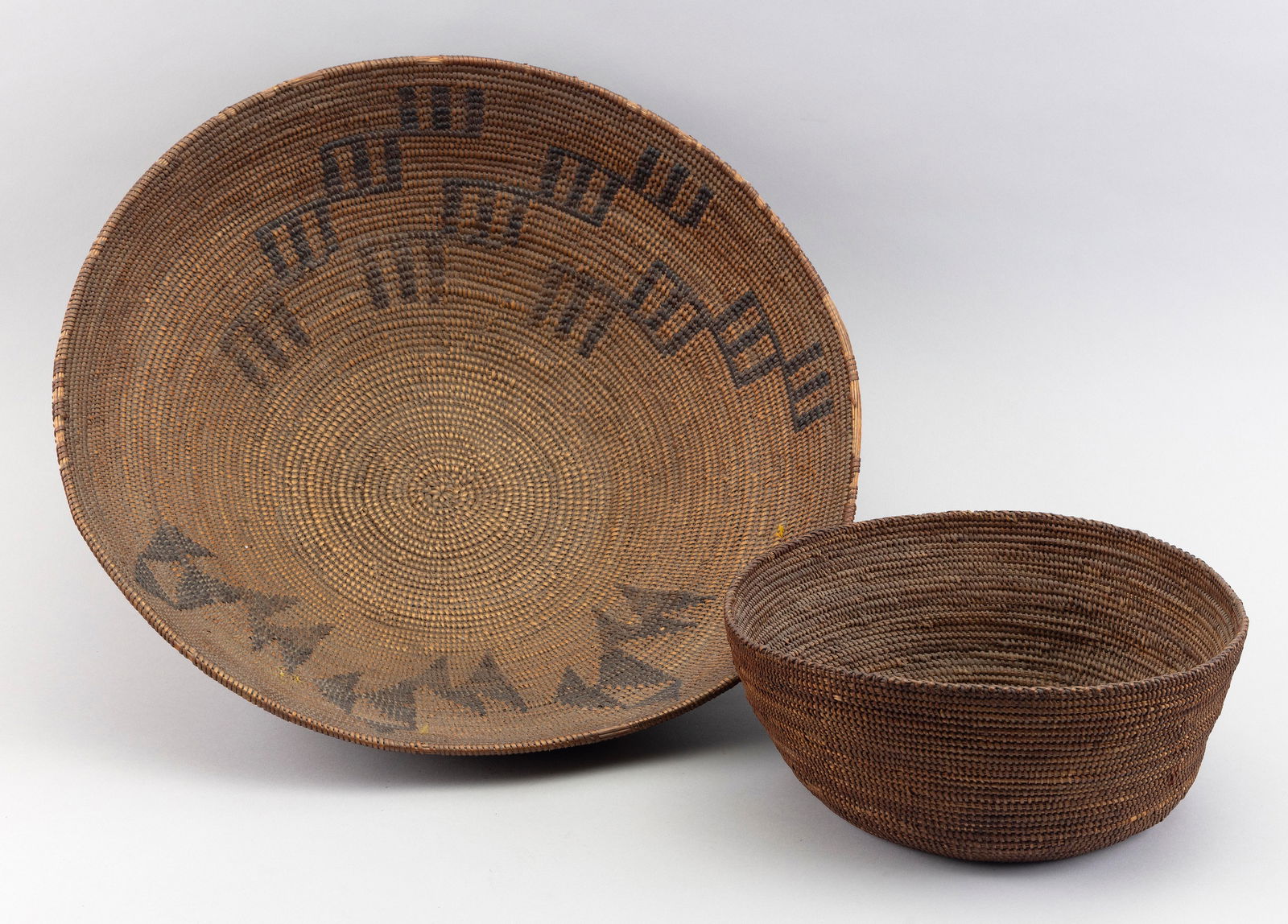 TWO PLAINS INDIAN HANDWOVEN BASKETS Early 20th Century Diameters 10.5” and 17”. (1 of 2)